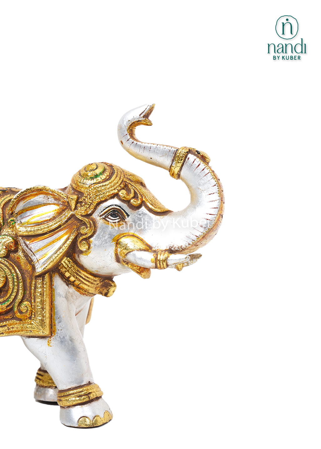 Handcrafted brass elephant with silver and gold detailing and ornate bell carving for luxury home décor.