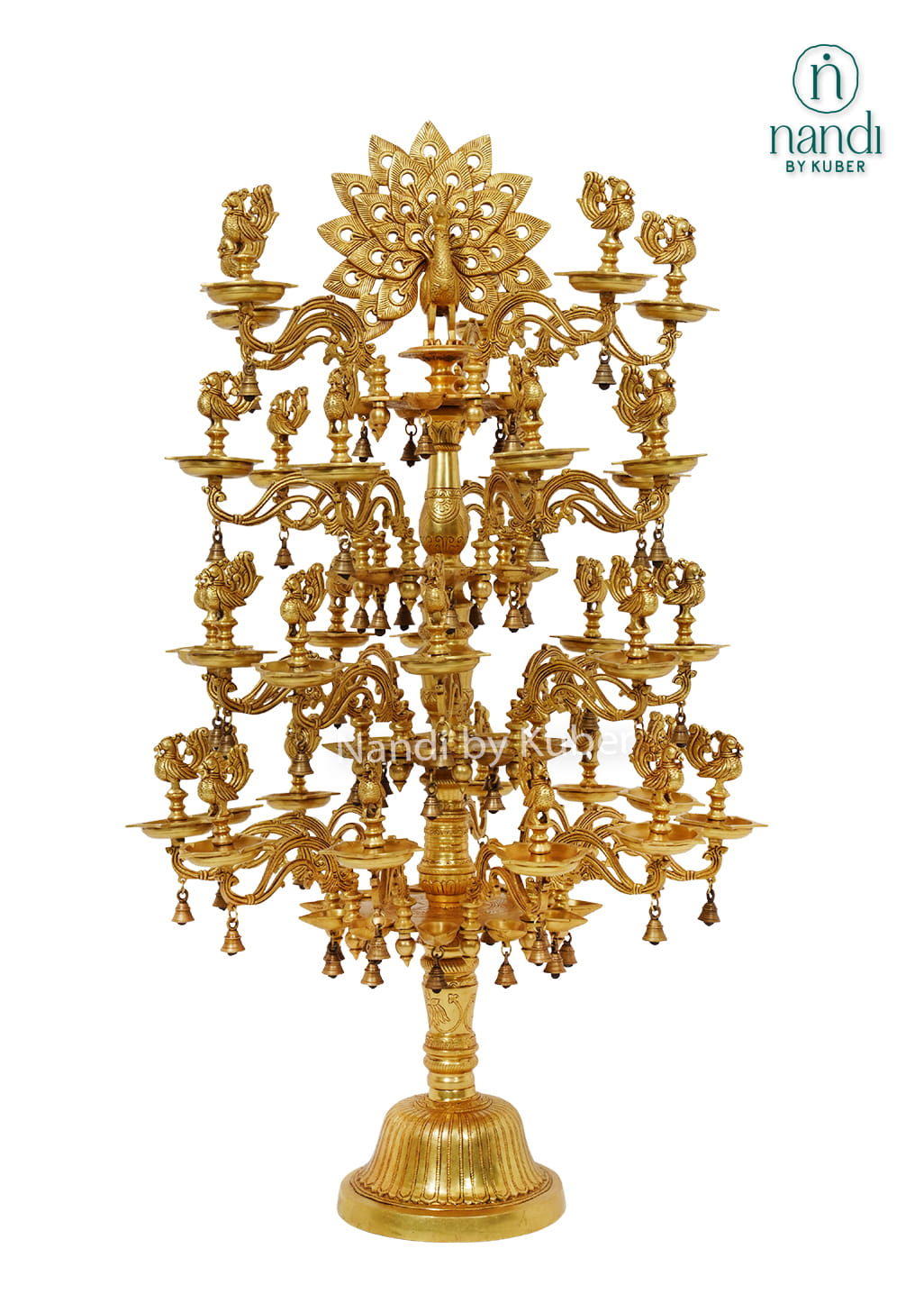 Large handcrafted brass Deepam with multiple oil lamp tiers, peacock motifs, floral detailing, and hanging bells for temples and pooja spaces.