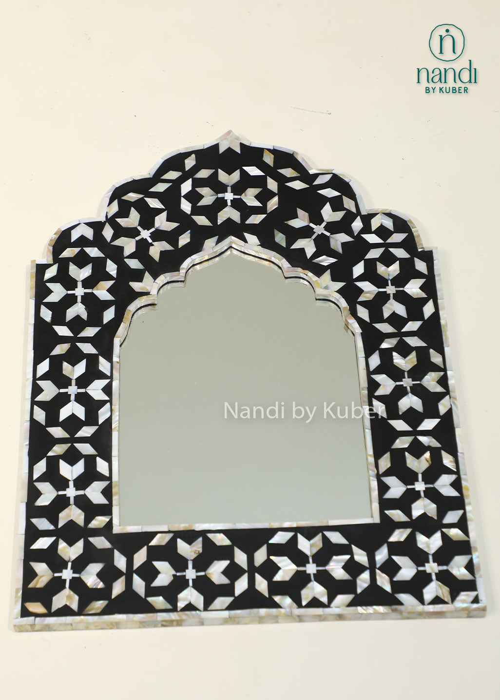Elegant mother-of-pearl mirror frame with intricate geometric inlay and an arched design, adding timeless sophistication to any interior.