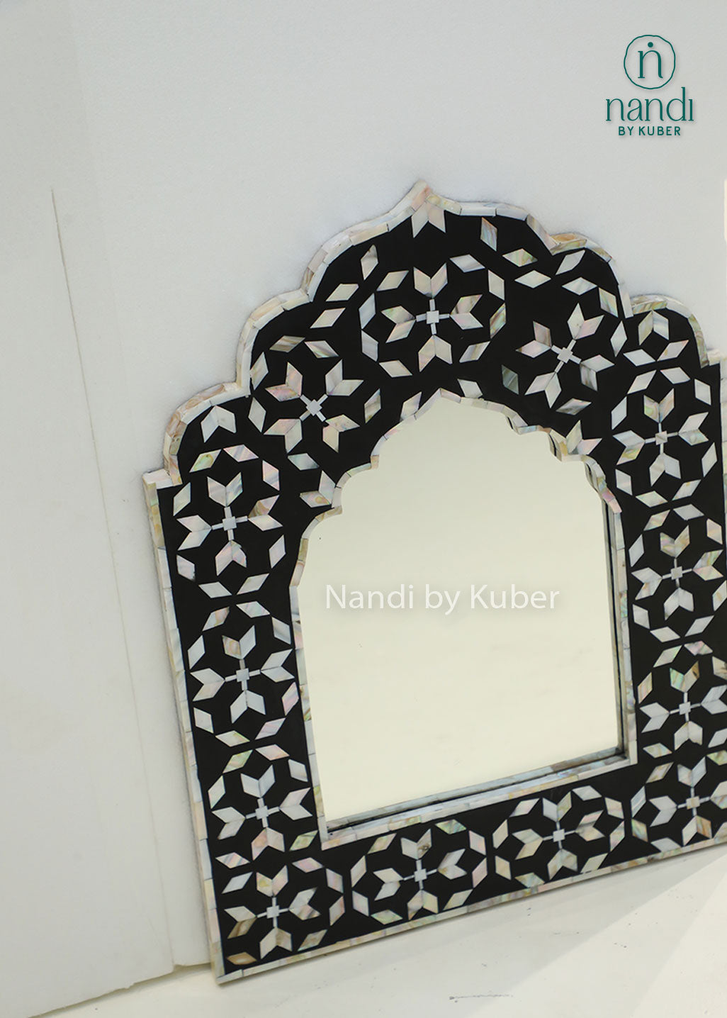 Elegant mother-of-pearl mirror frame with intricate geometric inlay and an arched design, adding timeless sophistication to any interior.
