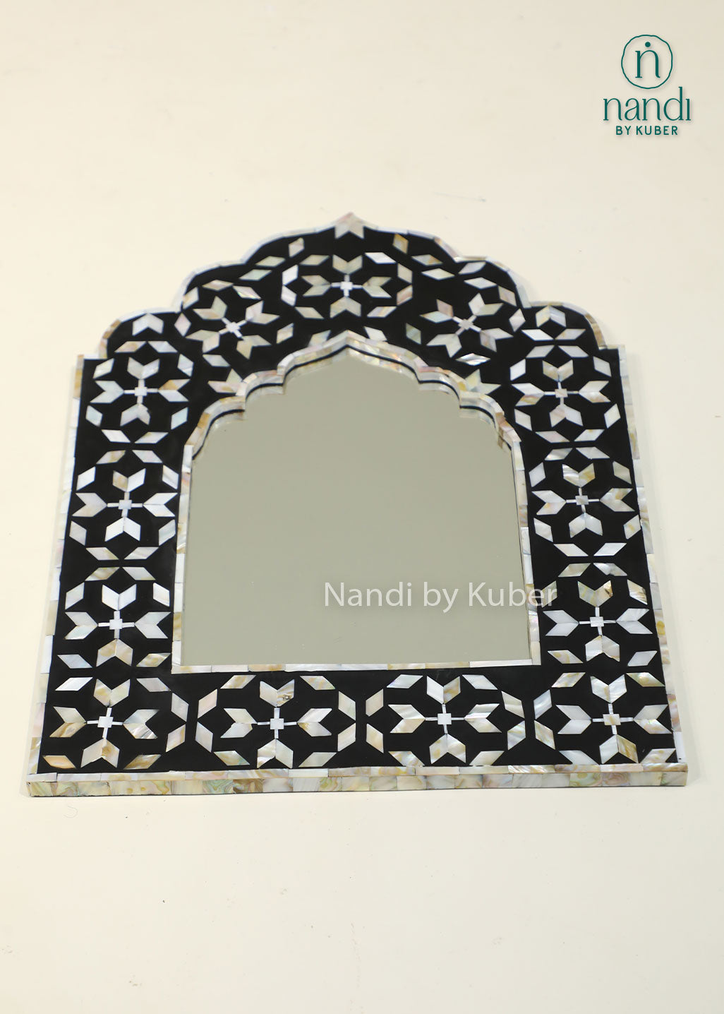 Elegant mother-of-pearl mirror frame with intricate geometric inlay and an arched design, adding timeless sophistication to any interior.