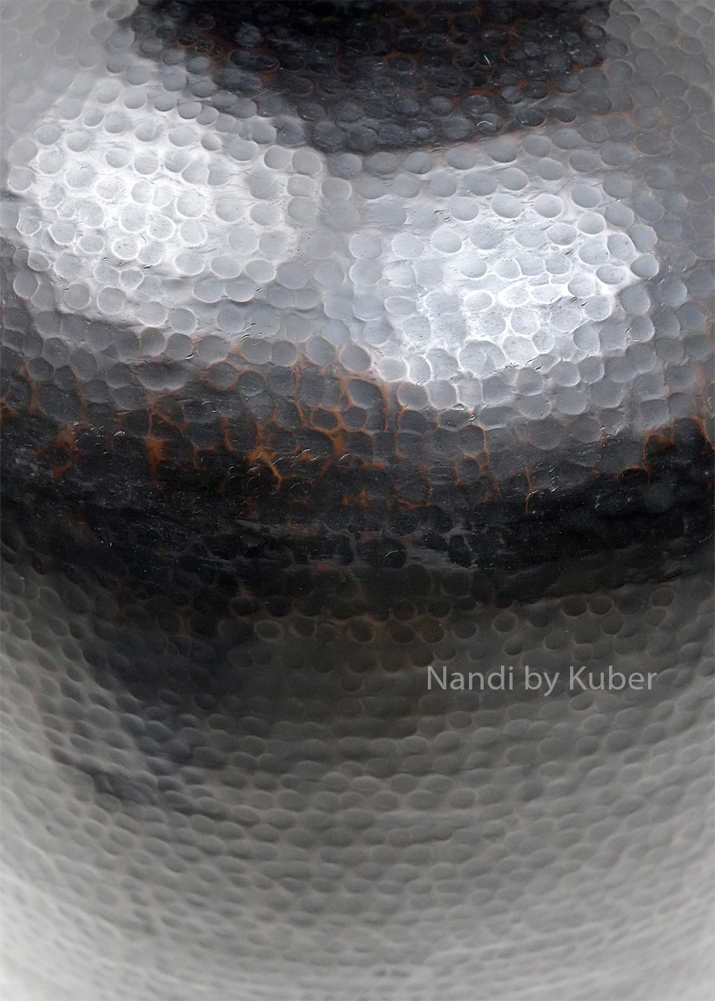Decorative hammered aluminium planter vase with an antique black finish, perfect for displaying plants and enhancing modern or rustic interiors.