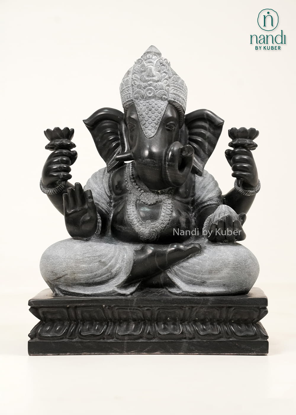 Black and white marble-style Lord Ganesha statue with intricate carvings, lotus motifs, and an elegant dual-tone finish.