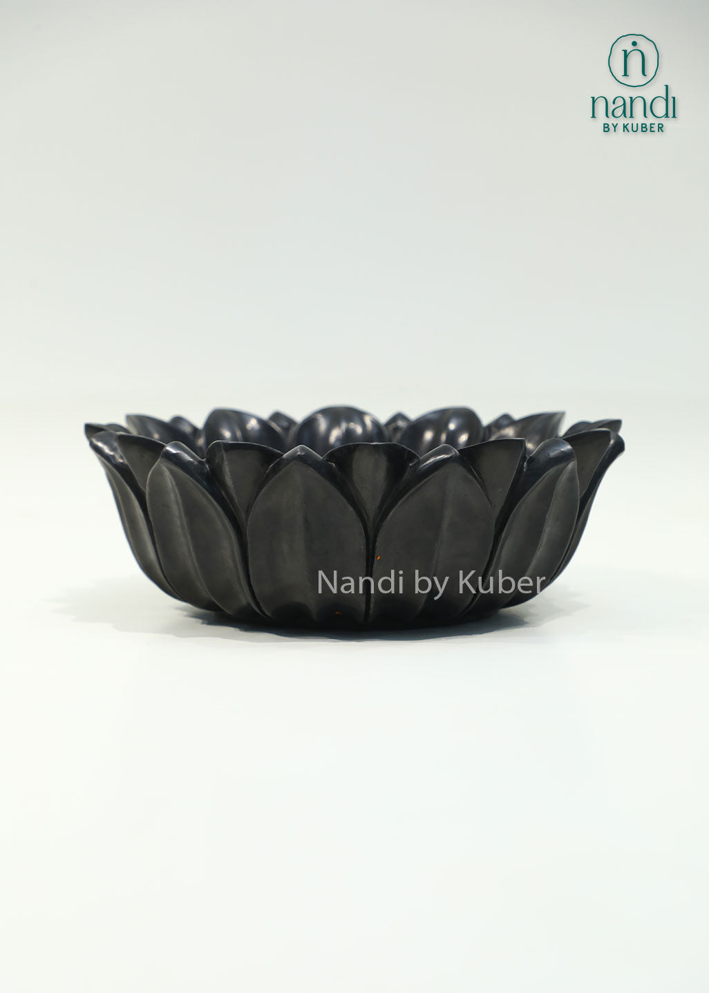 Handcrafted black marble lotus urli with elegant layered petals, perfect for floating flowers, candles, and decorative centerpieces.