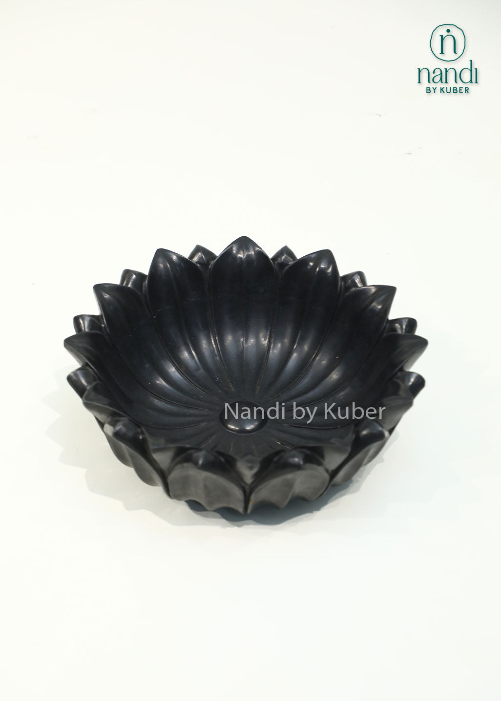 Handcrafted black marble lotus urli with elegant layered petals, perfect for floating flowers, candles, and decorative centerpieces.