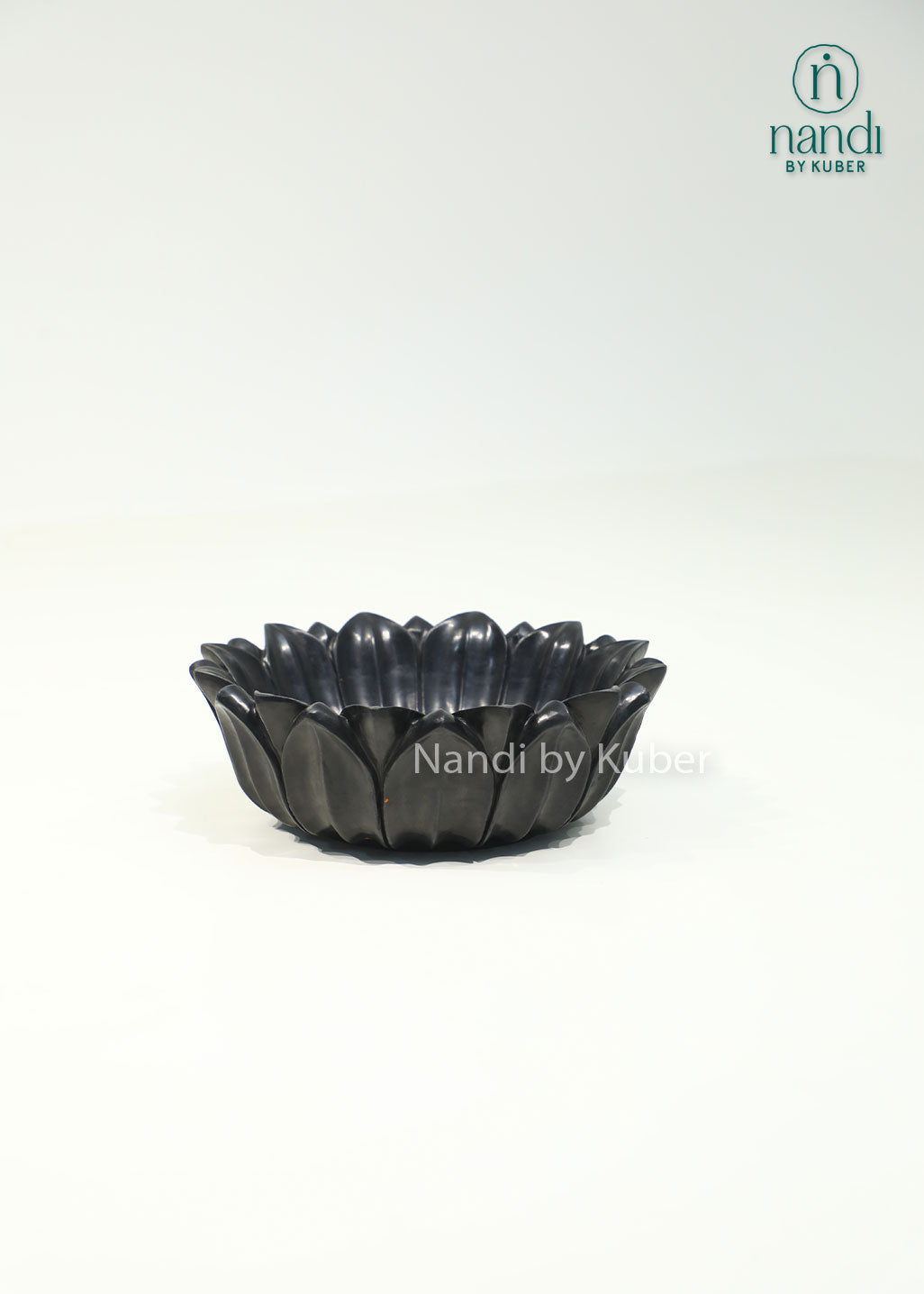 Handcrafted black marble lotus urli with elegant layered petals, perfect for floating flowers, candles, and decorative centerpieces.