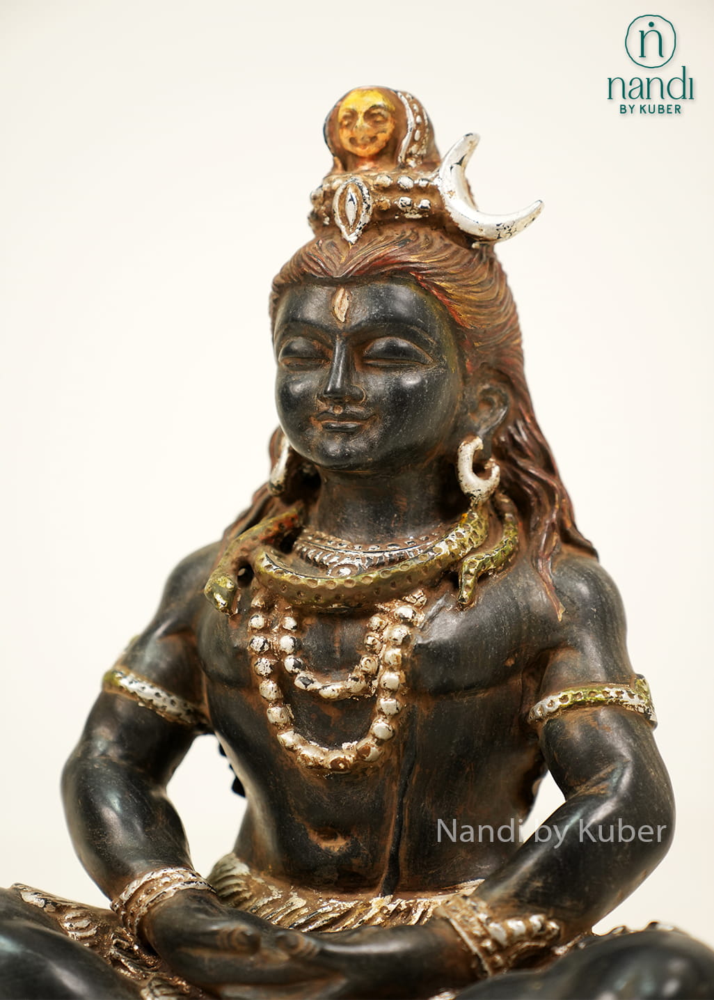 Black marble-style Lord Shiva statue in a meditative pose with detailed ornaments and an intricately crafted decorative base.