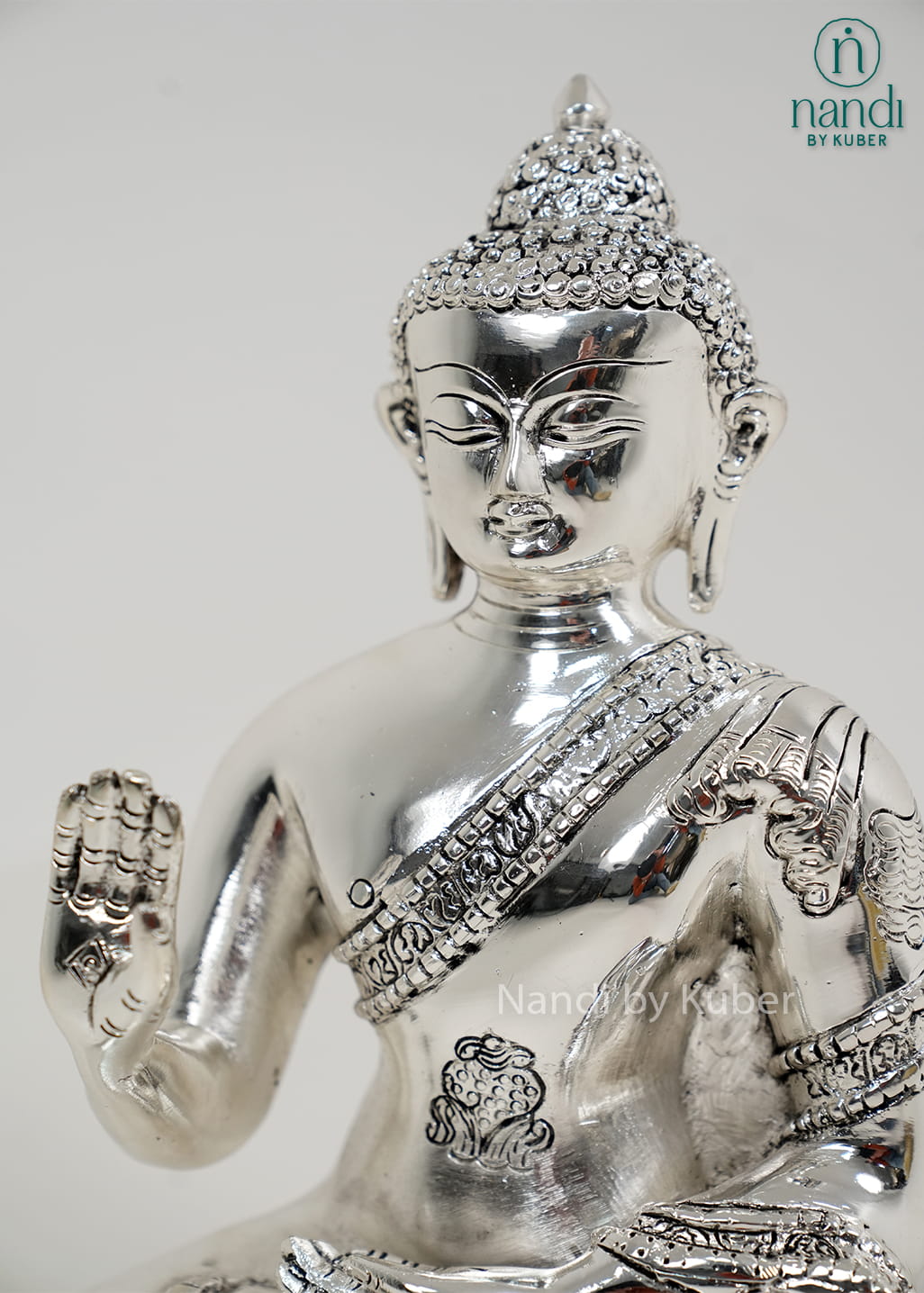 Silver Buddha statue with Ashtamangala detailing