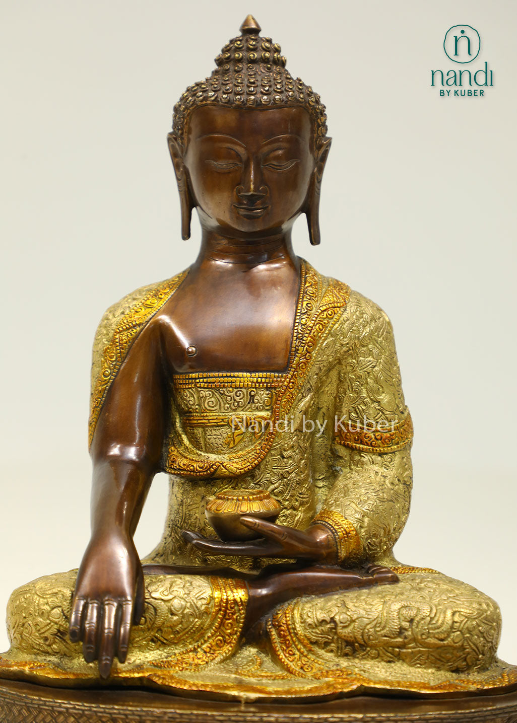 Handcrafted brass Buddha statue with antique bronze and gold finish, seated on a detailed lotus pedestal, perfect for meditation and spiritual décor.