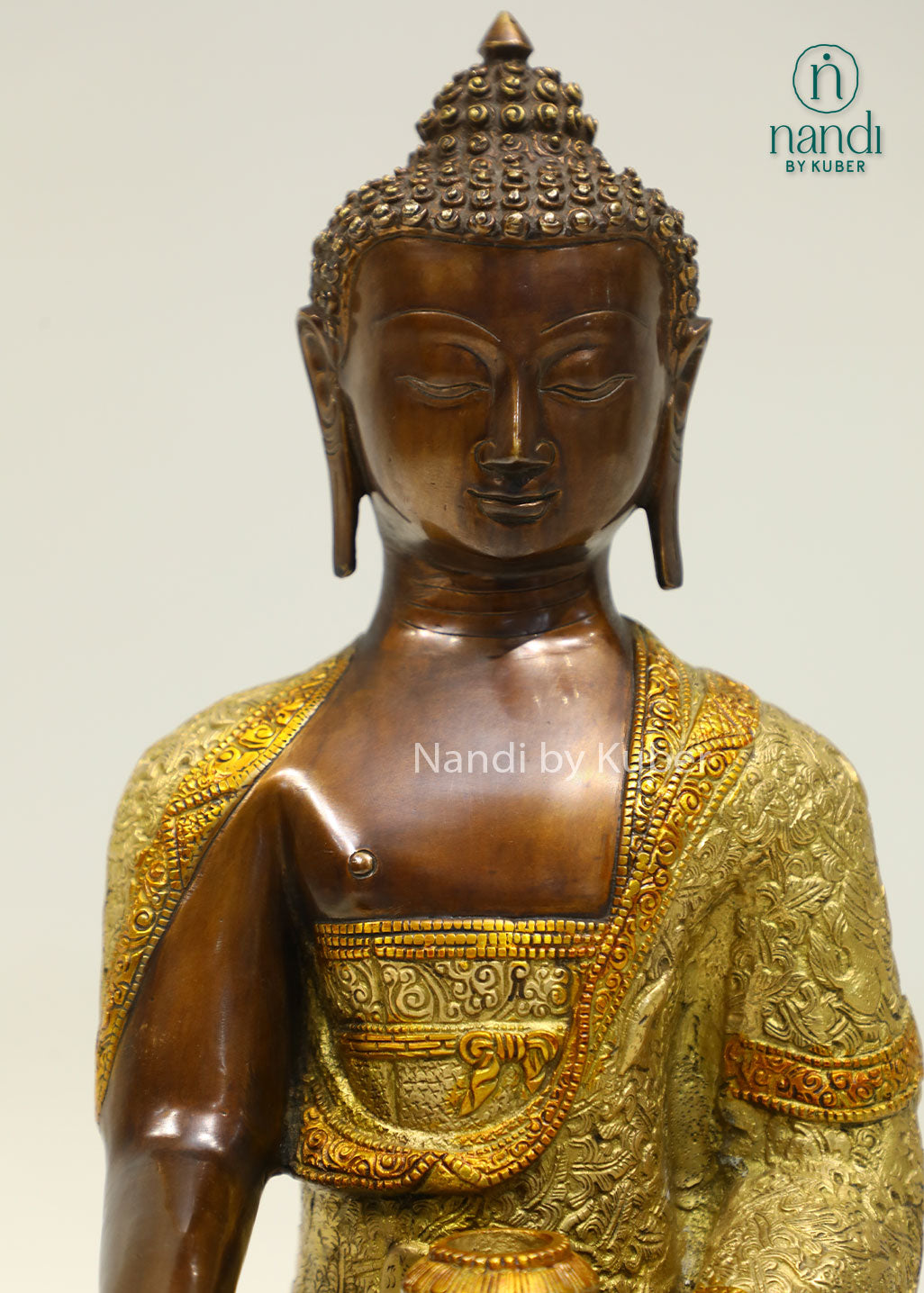 Handcrafted brass Buddha statue with antique bronze and gold finish, seated on a detailed lotus pedestal, perfect for meditation and spiritual décor.