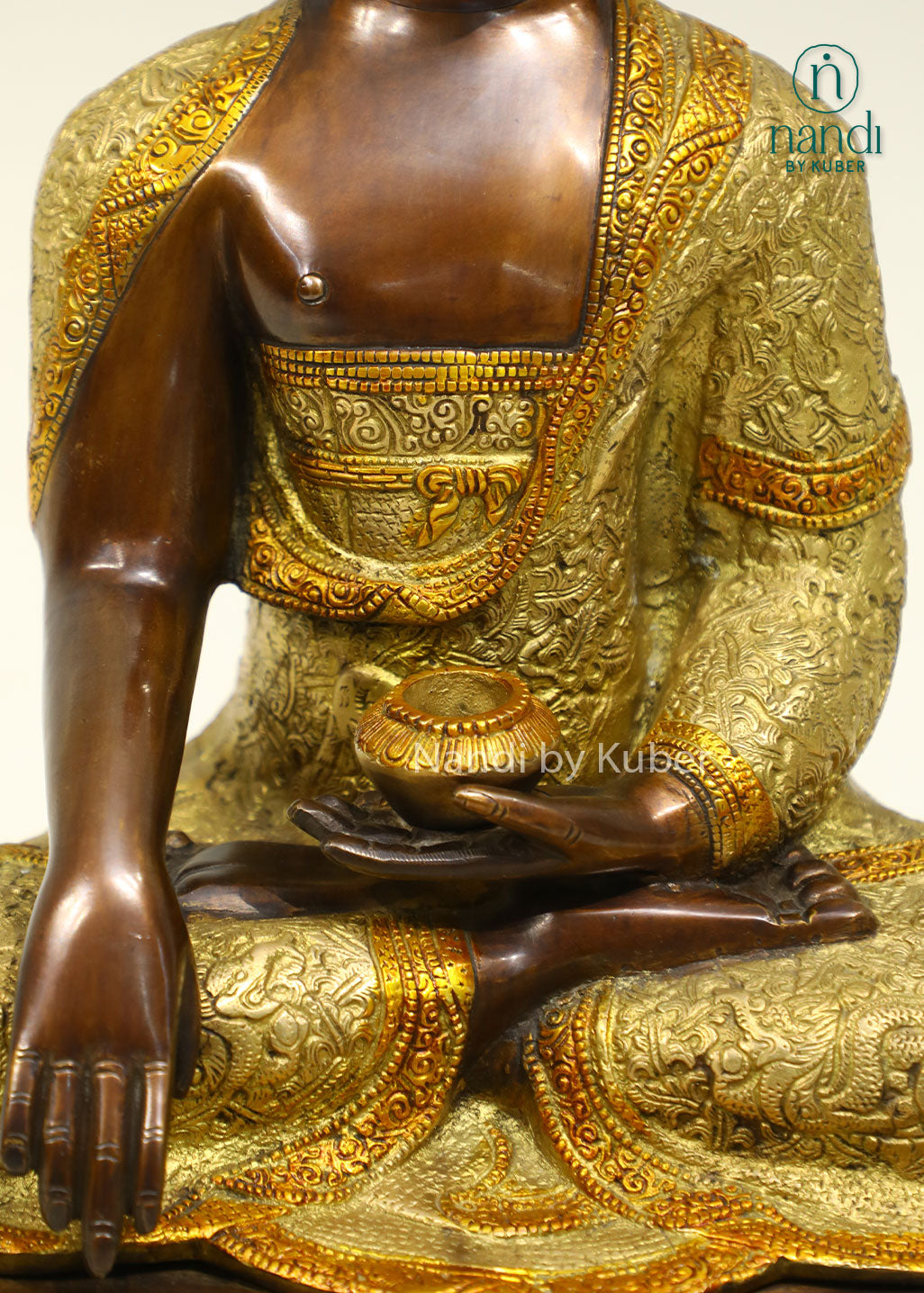 Handcrafted brass Buddha statue with antique bronze and gold finish, seated on a detailed lotus pedestal, perfect for meditation and spiritual décor.
