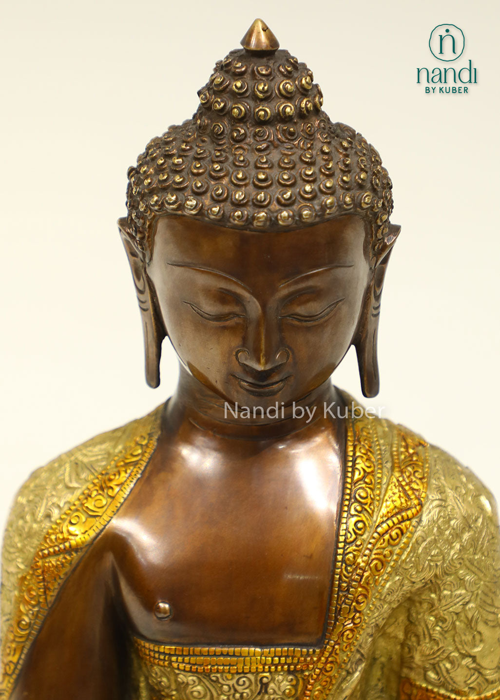 Handcrafted brass Buddha statue with antique bronze and gold finish, seated on a detailed lotus pedestal, perfect for meditation and spiritual décor.