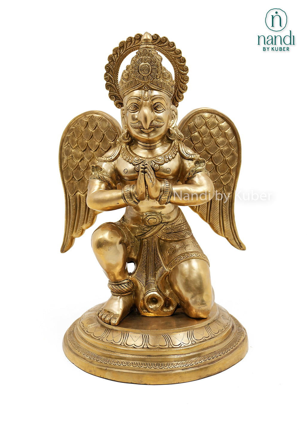 Handcrafted brass Garuda sitting statue with folded hands, detailed wings, ornate crown, and round pedestal, ideal for home temples, spiritual décor, and sacred spaces.