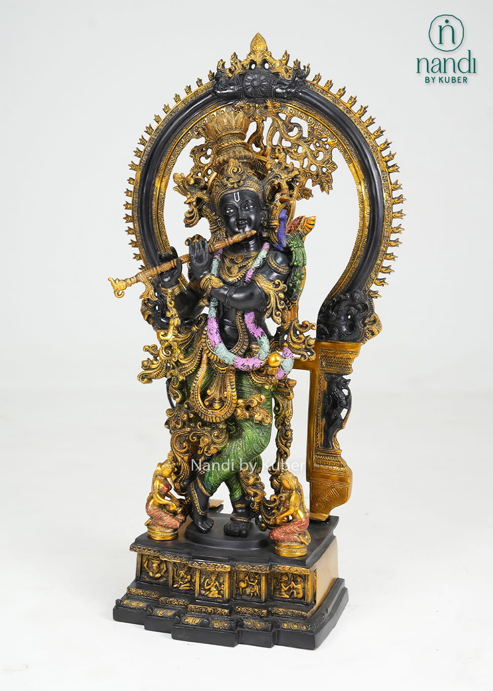 Decorative brass Krishna statue with ornate arch, flute, and multicolor detailing