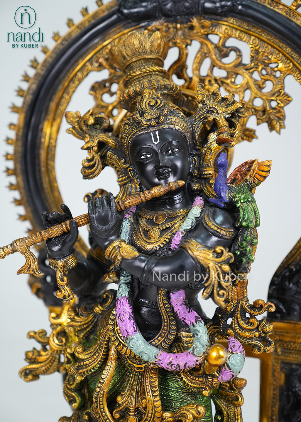 Decorative brass Krishna statue with ornate arch, flute, and multicolor detailing