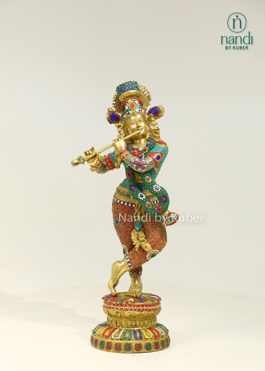 Intricately handcrafted brass Lord Krishna flute-playing statue with colorful ring work and decorative embellishments, perfect for spiritual and decorative settings.