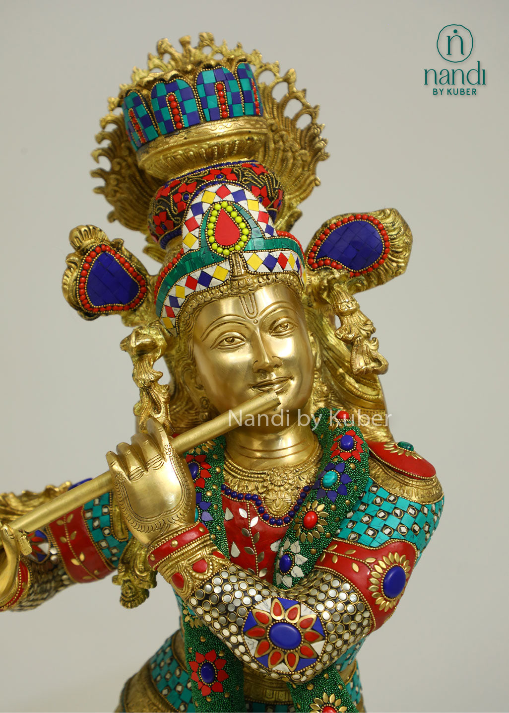 Intricately handcrafted brass Lord Krishna flute-playing statue with colorful ring work and decorative embellishments, perfect for spiritual and decorative settings.