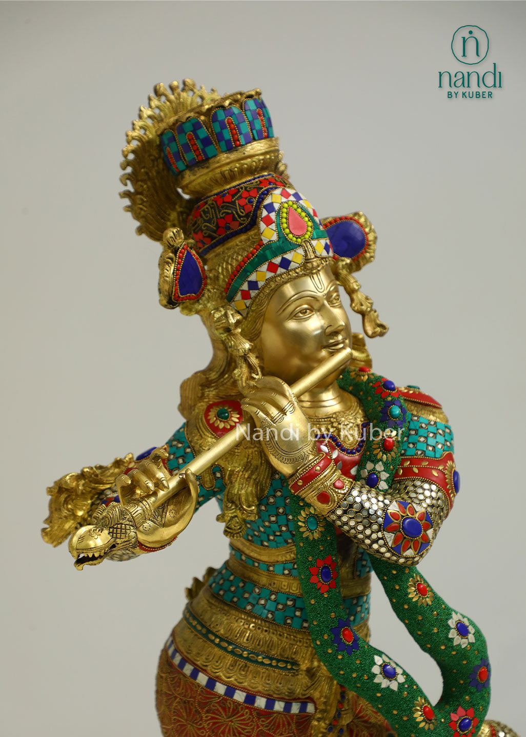 Intricately handcrafted brass Lord Krishna flute-playing statue with colorful ring work and decorative embellishments, perfect for spiritual and decorative settings.