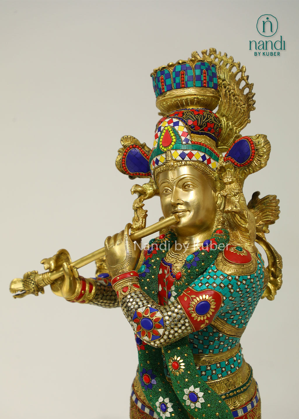 Intricately handcrafted brass Lord Krishna flute-playing statue with colorful ring work and decorative embellishments, perfect for spiritual and decorative settings.