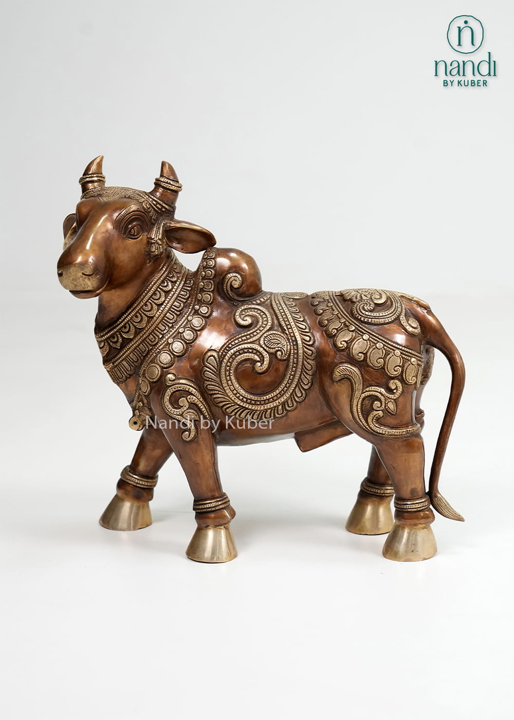 Two-tone brass Nandi bull statue with intricate carvings