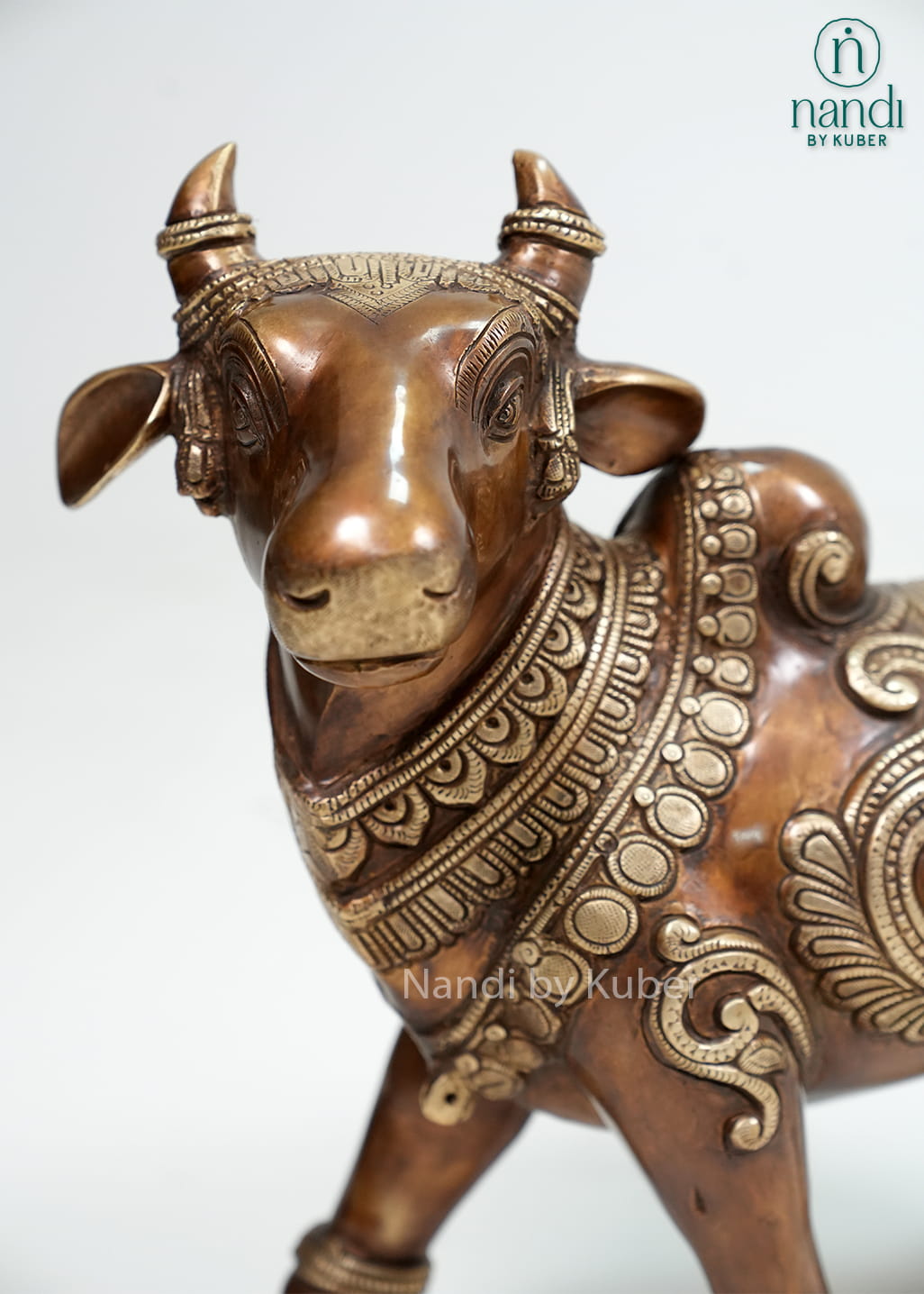 Two-tone brass Nandi bull statue with intricate carvings