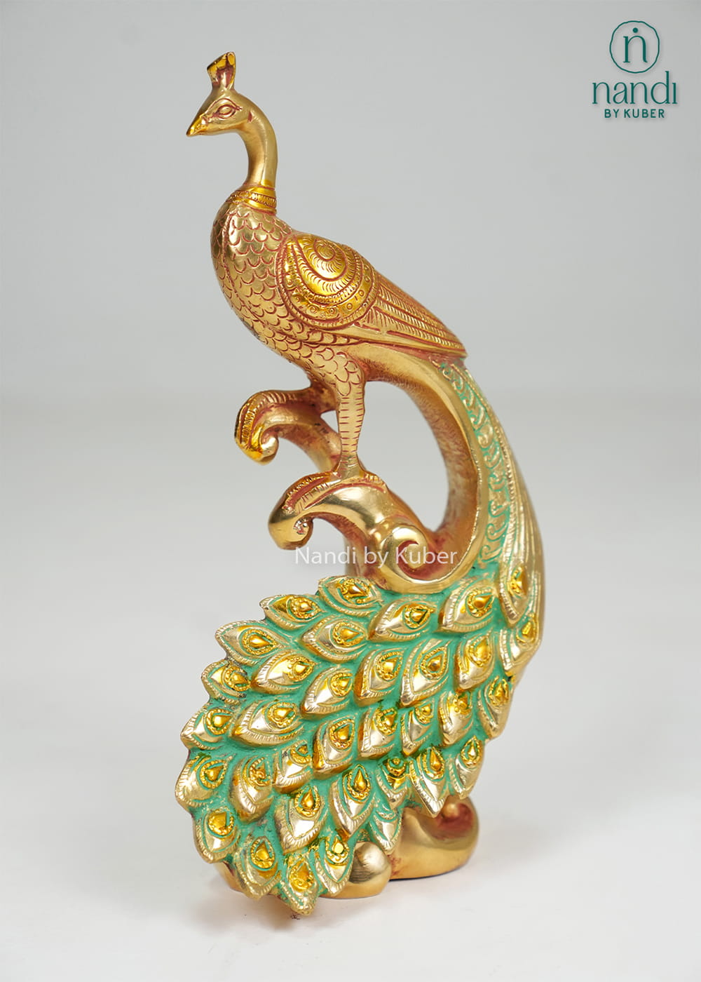 Brass peacock on decorative branch with enamel tail detailing