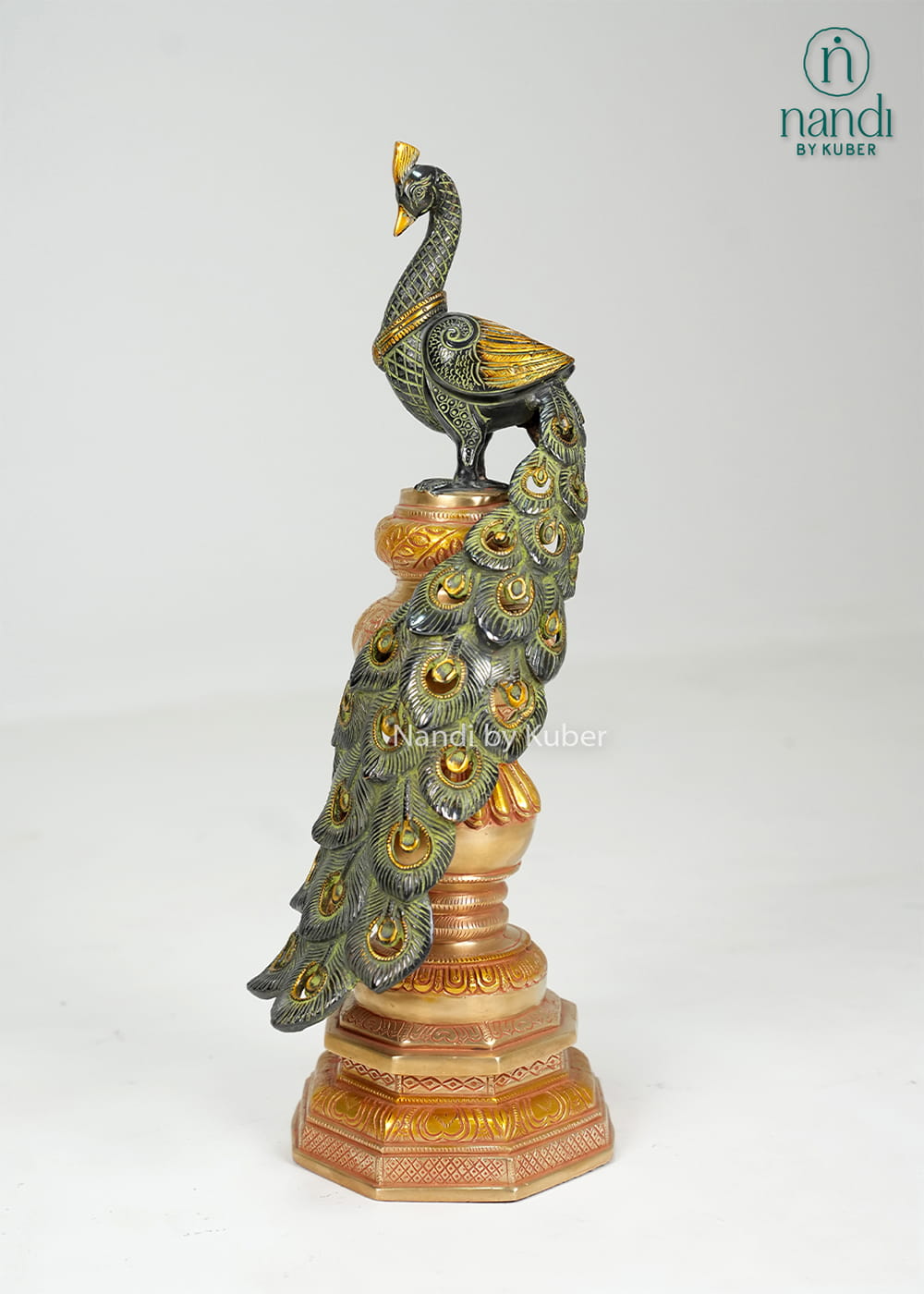 Brass peacock statue on decorative pedestal with detailed feather work
