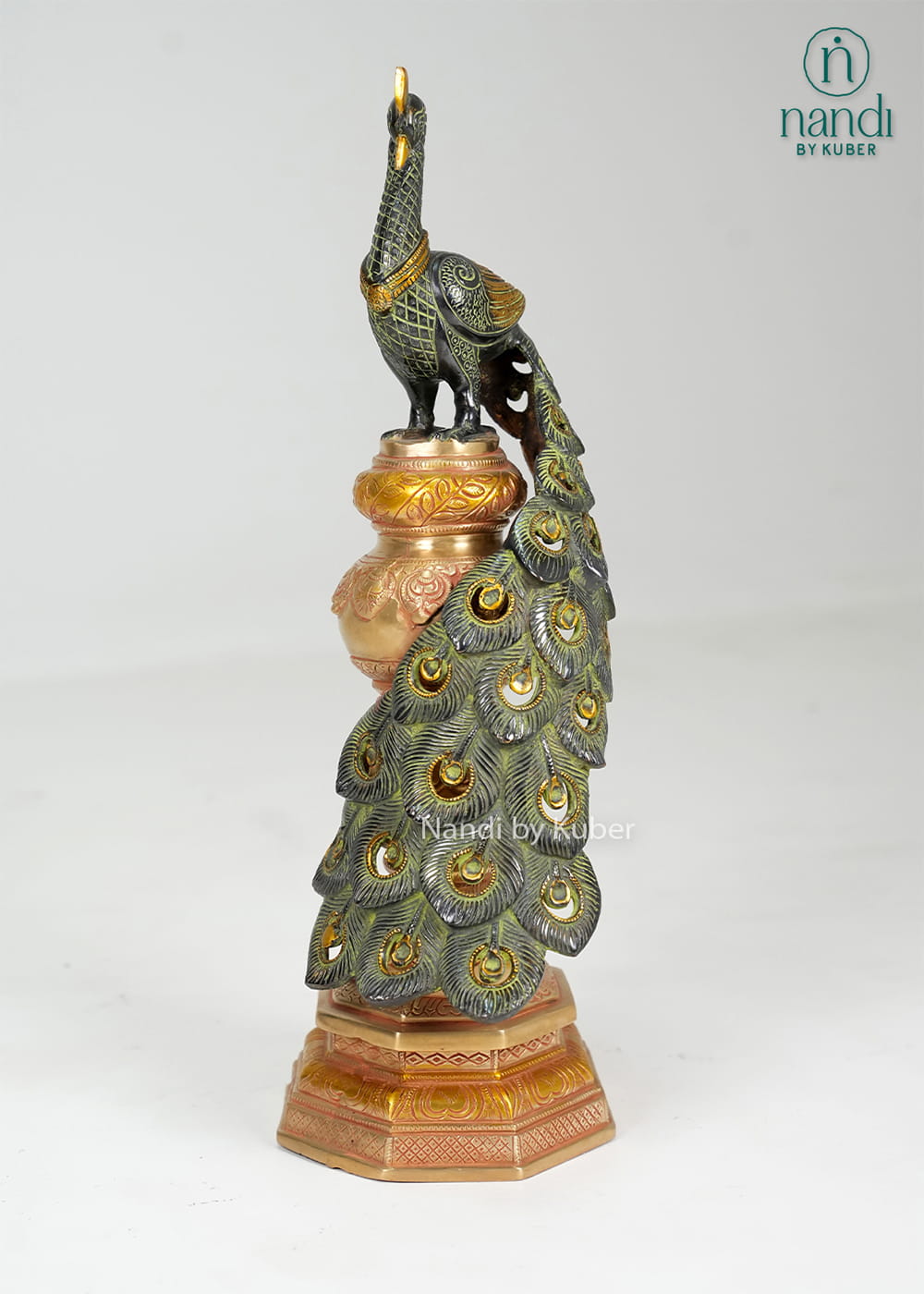 Brass peacock statue on decorative pedestal with detailed feather work