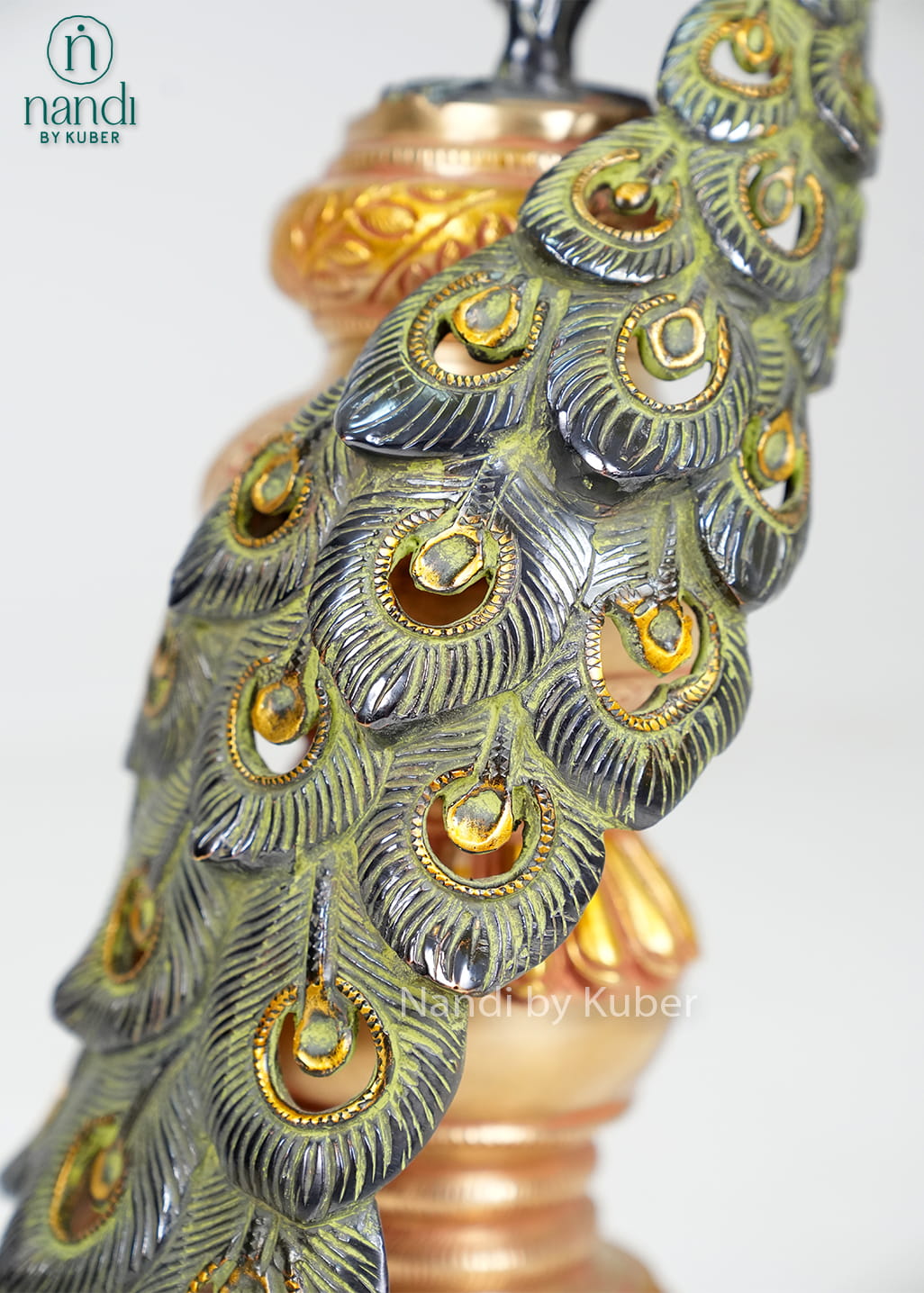 Brass peacock statue on decorative pedestal with detailed feather work