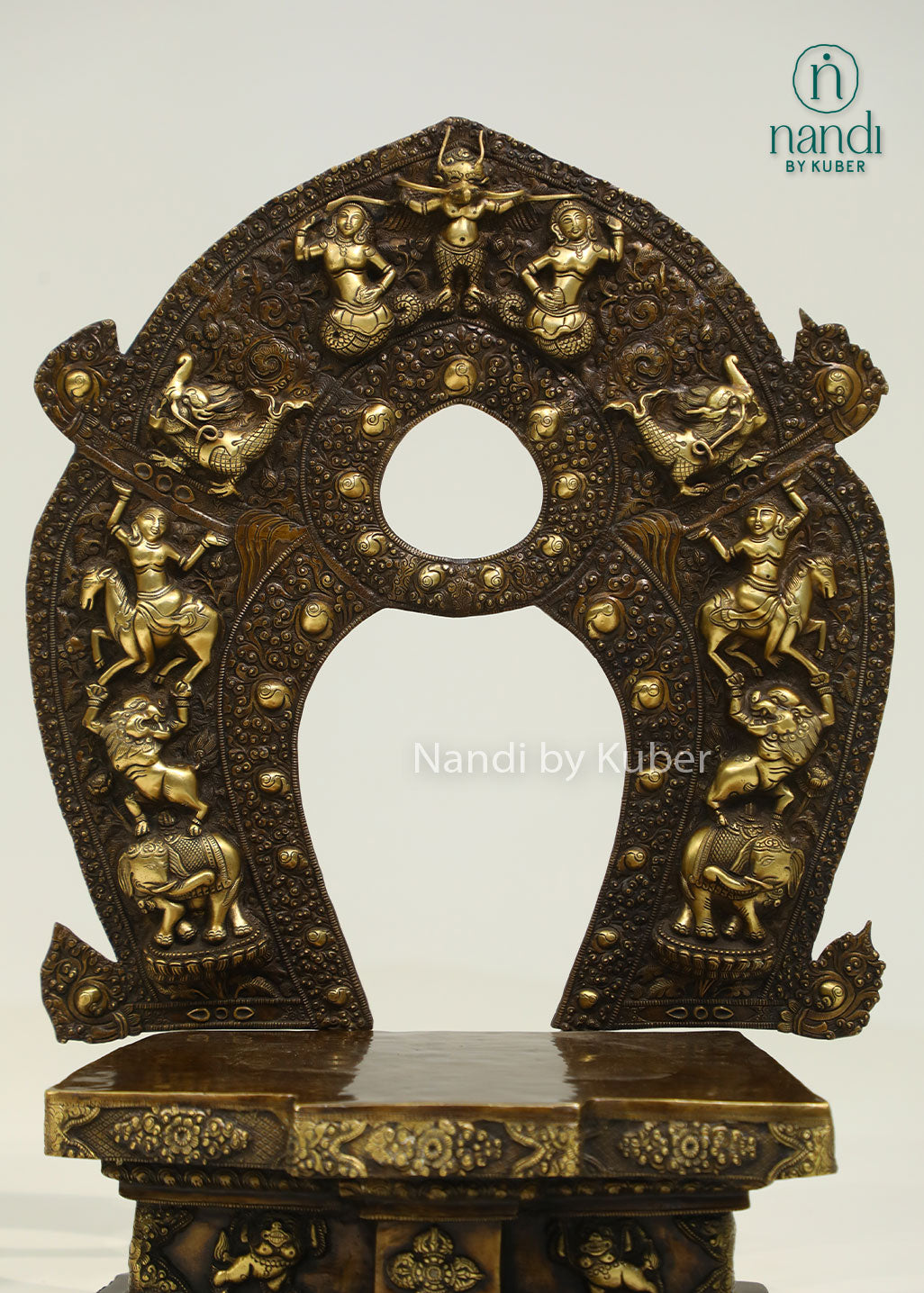 Intricately crafted brass sinhasan with an ornate arched design, perfect for displaying Buddha statues and enhancing sacred spaces with timeless elegance.