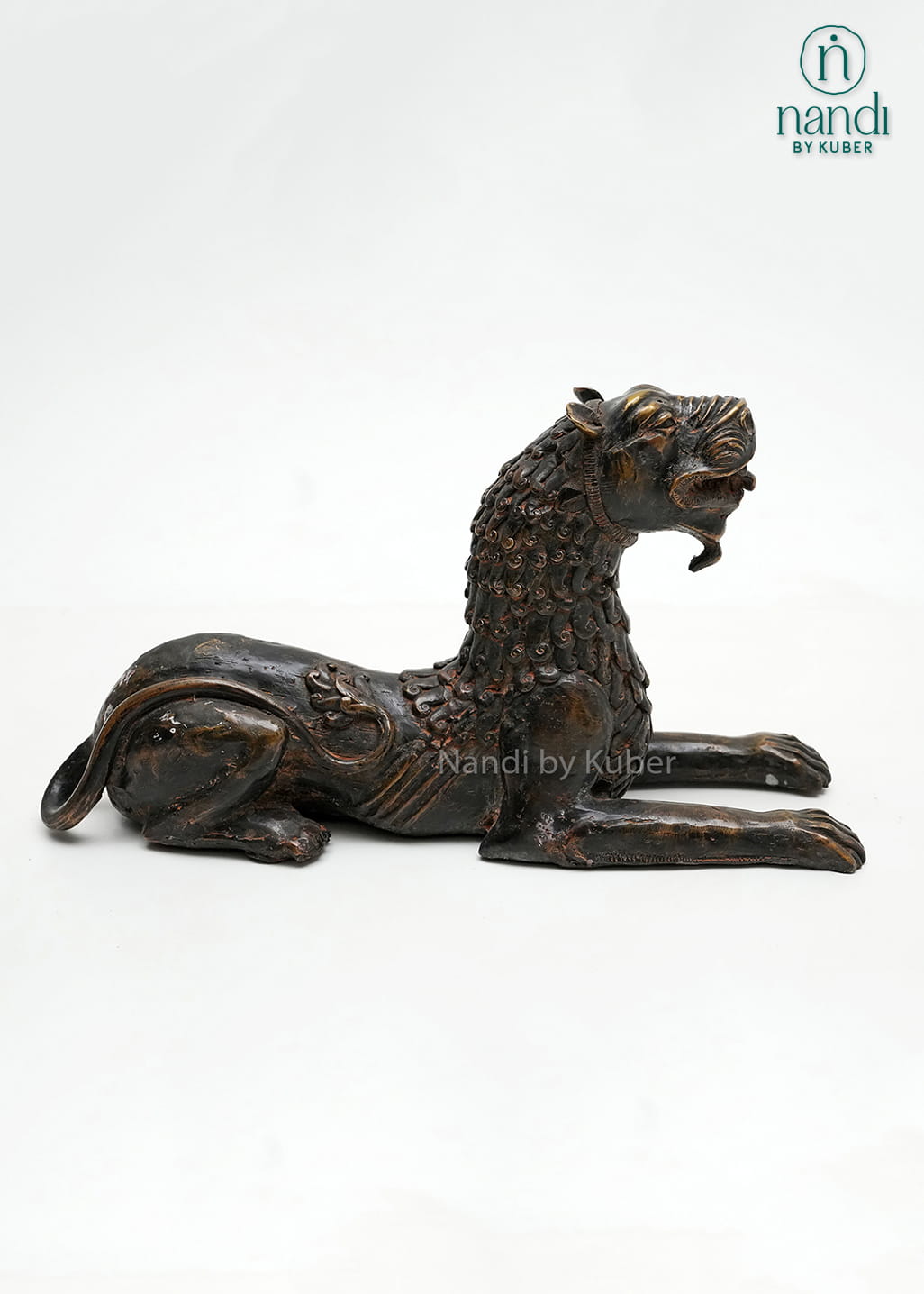 Decorative brass tiger statue in a reclining pose with an antique finish, symbolizing strength, courage, and power.