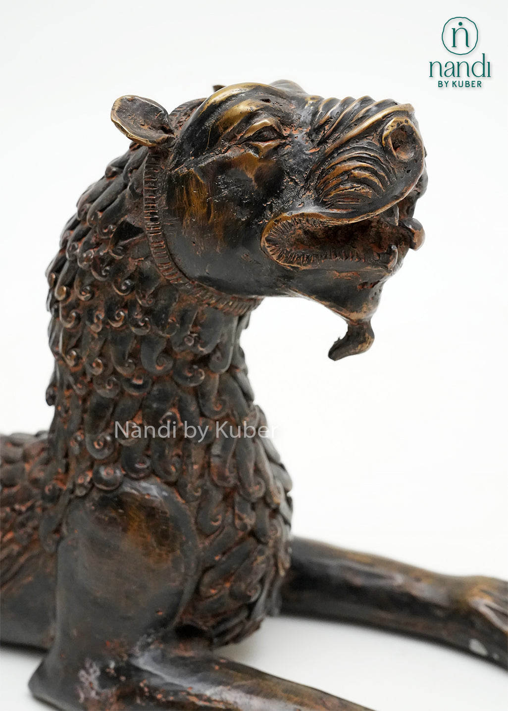 Decorative brass tiger statue in a reclining pose with an antique finish, symbolizing strength, courage, and power.