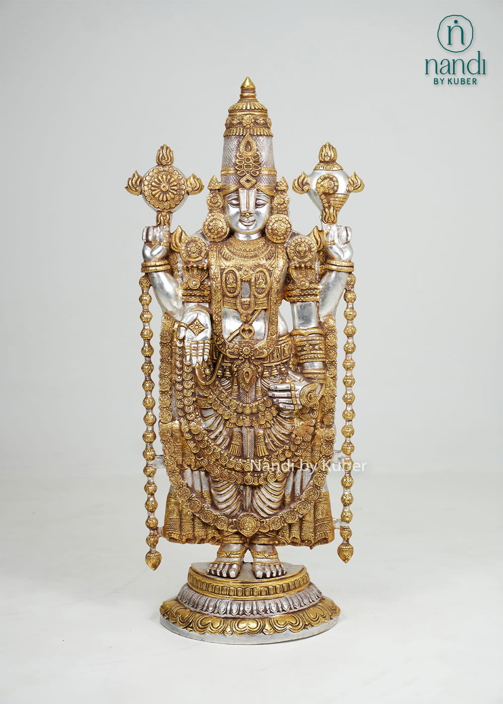Silver and gold-tone Tirupati Balaji idol with intricate traditional detailing and decorative pedestal base