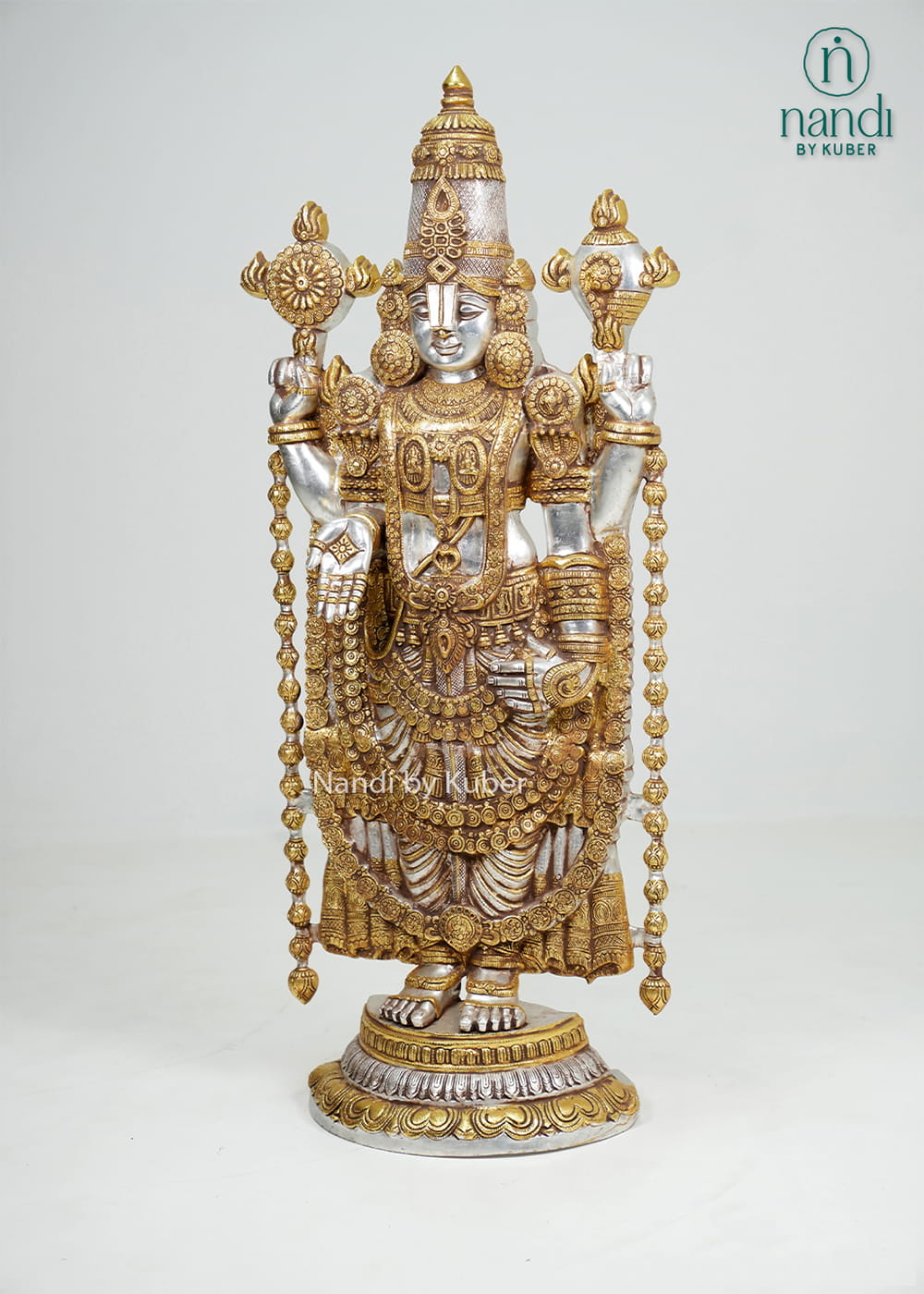 Silver and gold-tone Tirupati Balaji idol with intricate traditional detailing and decorative pedestal base