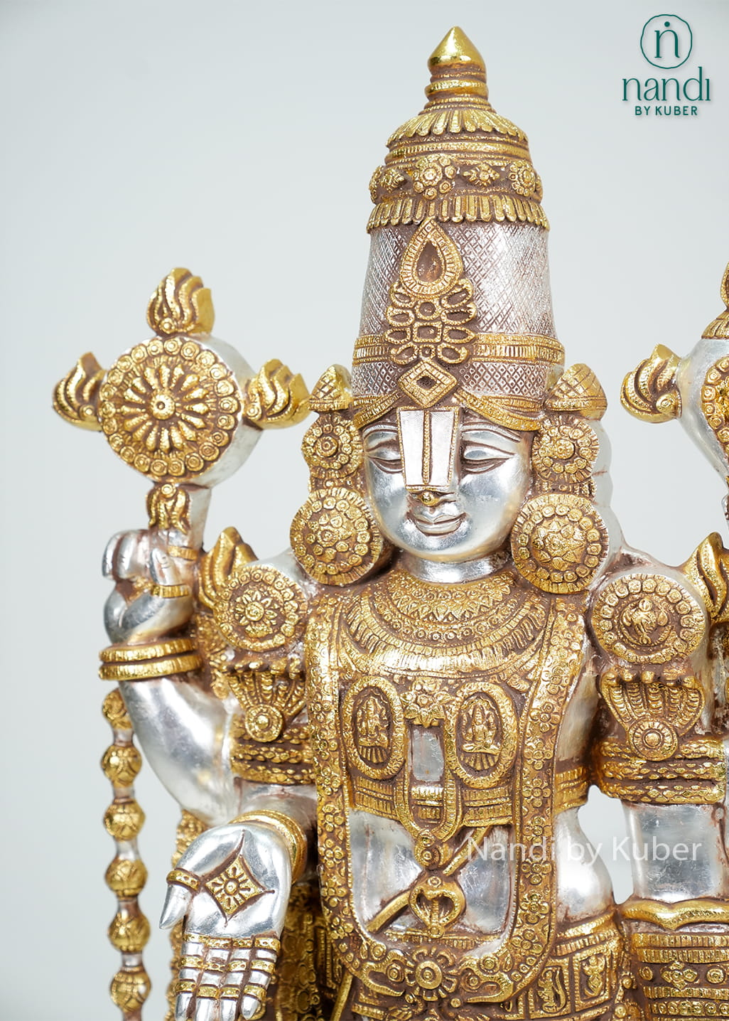 Silver and gold-tone Tirupati Balaji idol with intricate traditional detailing and decorative pedestal base