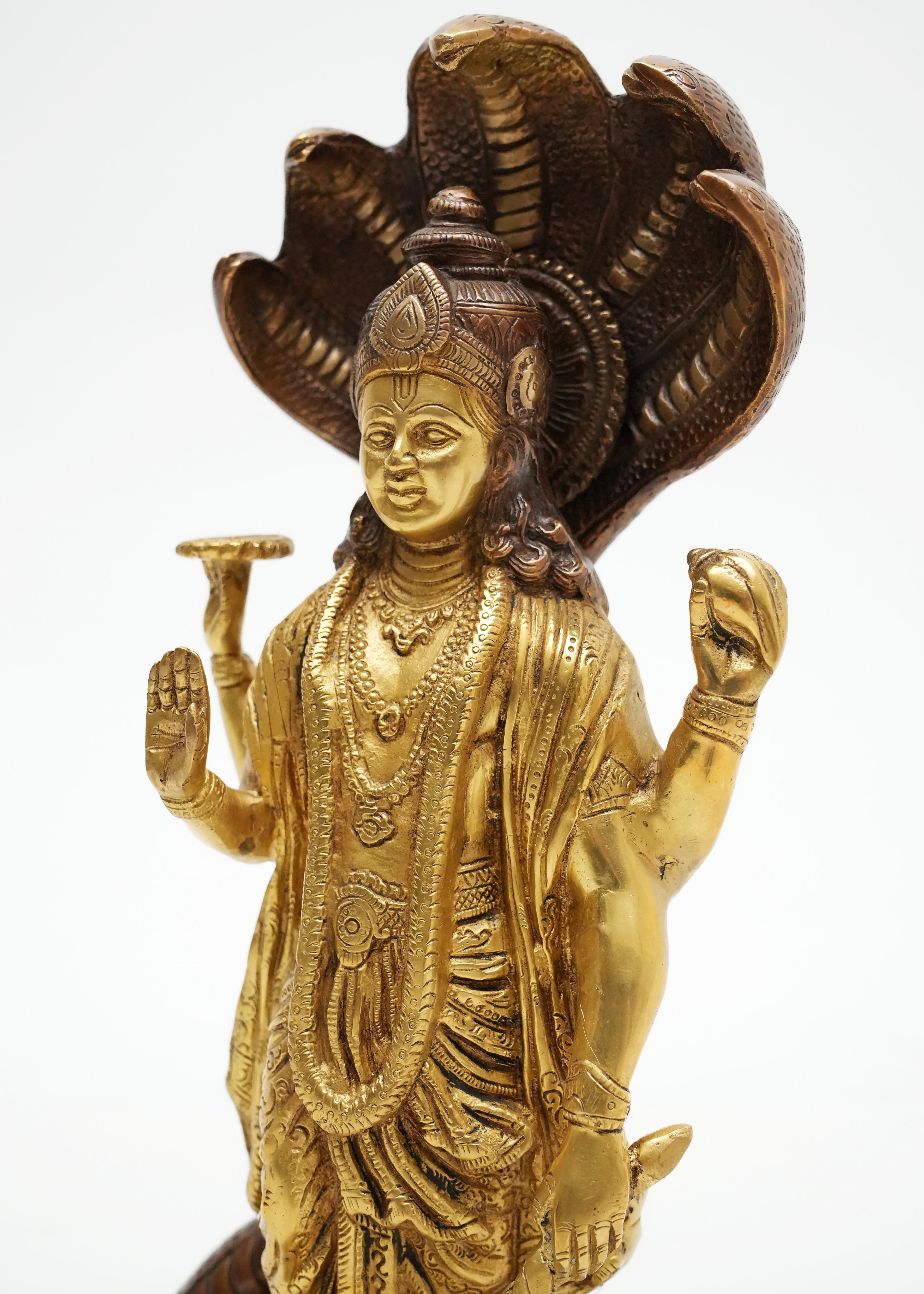 Handcrafted two-tone brass Vishnu idol with Sheshnag canopy, ornate carvings, and antique finish, ideal for pooja rooms, temples, spiritual décor, and traditional Indian home interiors.