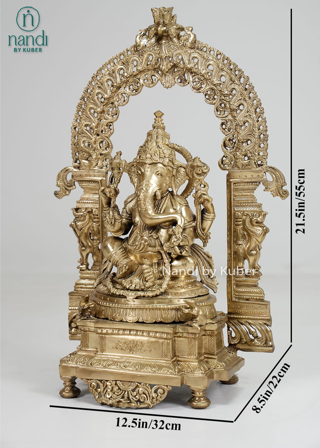 Bronze Ganesha statue with ornate temple arch and carved pedestal