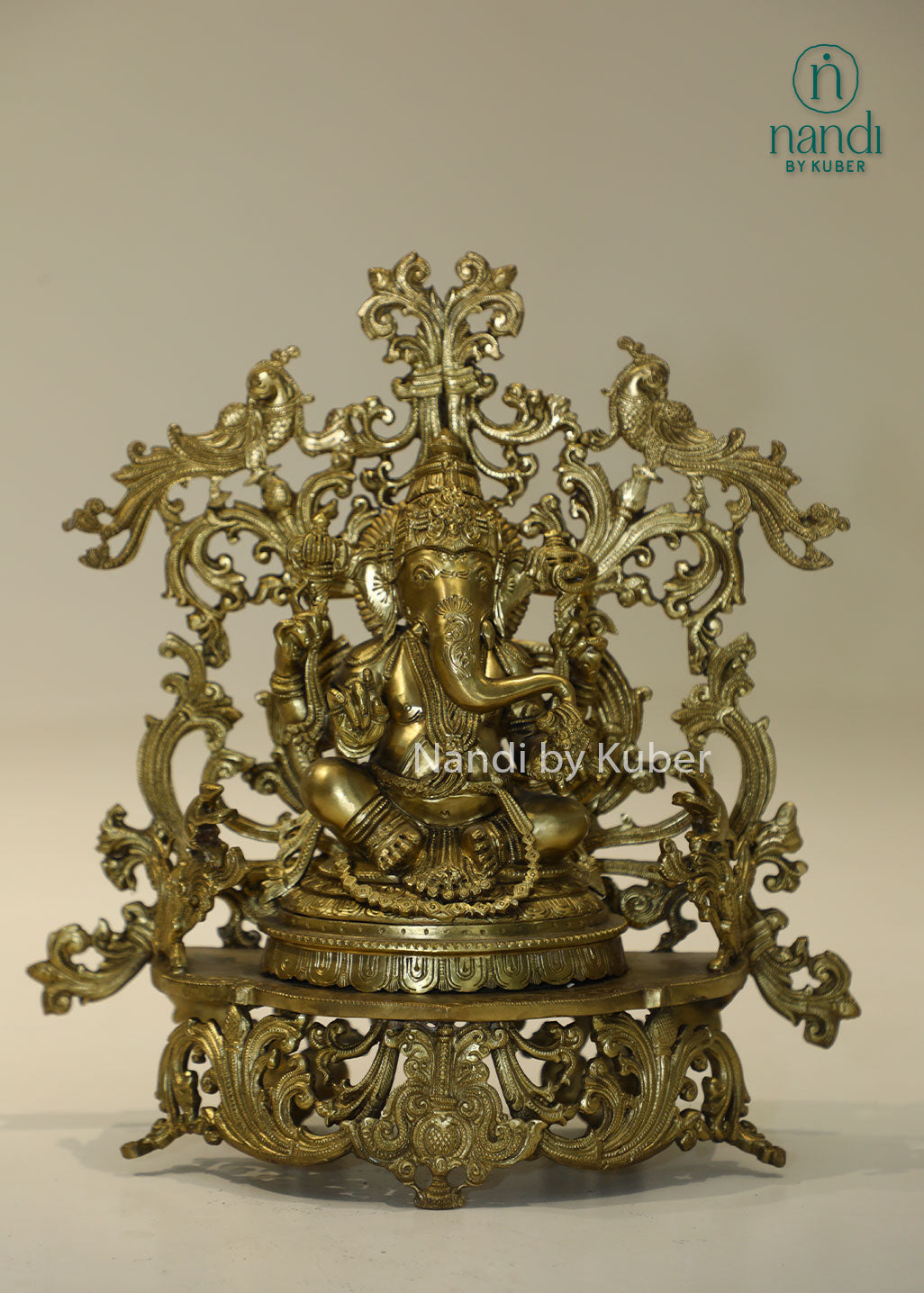 Bronze Ganesha idol with decorative floral arch, handcrafted Lord Ganesh statue for home temple, puja room décor, spiritual gifting, Vastu decoration, Hindu religious collectible, and festive worship.