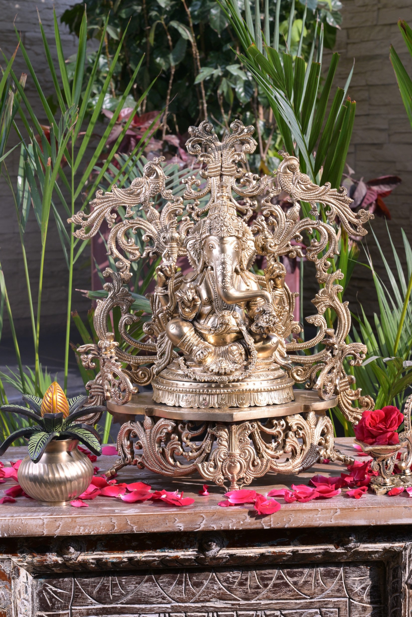 Bronze Ganesha idol with decorative floral arch, handcrafted Lord Ganesh statue for home temple, puja room décor, spiritual gifting, Vastu decoration, Hindu religious collectible, and festive worship.