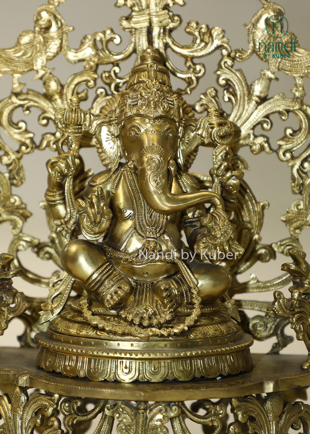 Bronze Ganesha idol with decorative floral arch, handcrafted Lord Ganesh statue for home temple, puja room décor, spiritual gifting, Vastu decoration, Hindu religious collectible, and festive worship.