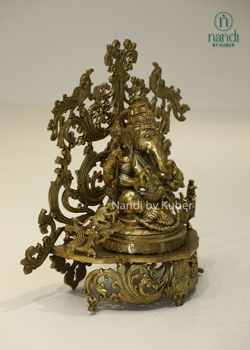 Bronze Ganesha idol with decorative floral arch, handcrafted Lord Ganesh statue for home temple, puja room décor, spiritual gifting, Vastu decoration, Hindu religious collectible, and festive worship.
