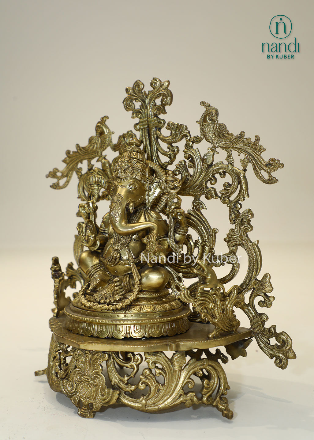 Bronze Ganesha idol with decorative floral arch, handcrafted Lord Ganesh statue for home temple, puja room décor, spiritual gifting, Vastu decoration, Hindu religious collectible, and festive worship.