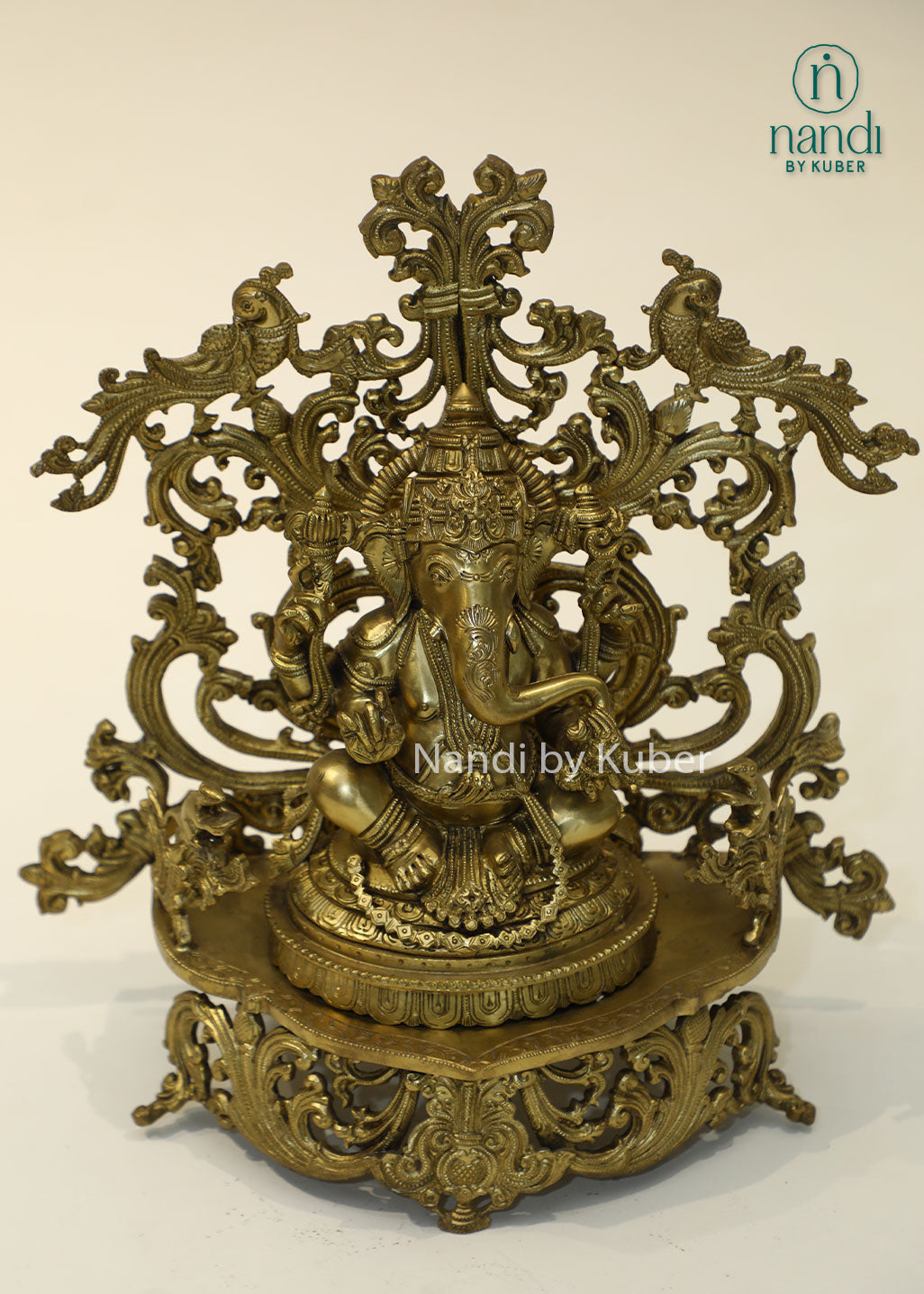 Bronze Ganesha idol with decorative floral arch, handcrafted Lord Ganesh statue for home temple, puja room décor, spiritual gifting, Vastu decoration, Hindu religious collectible, and festive worship.