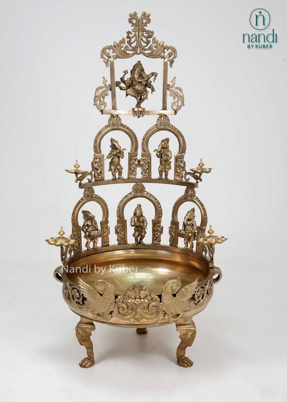 Decorative brass Ganesha urli with temple arch design, diya holders, and intricate detailing