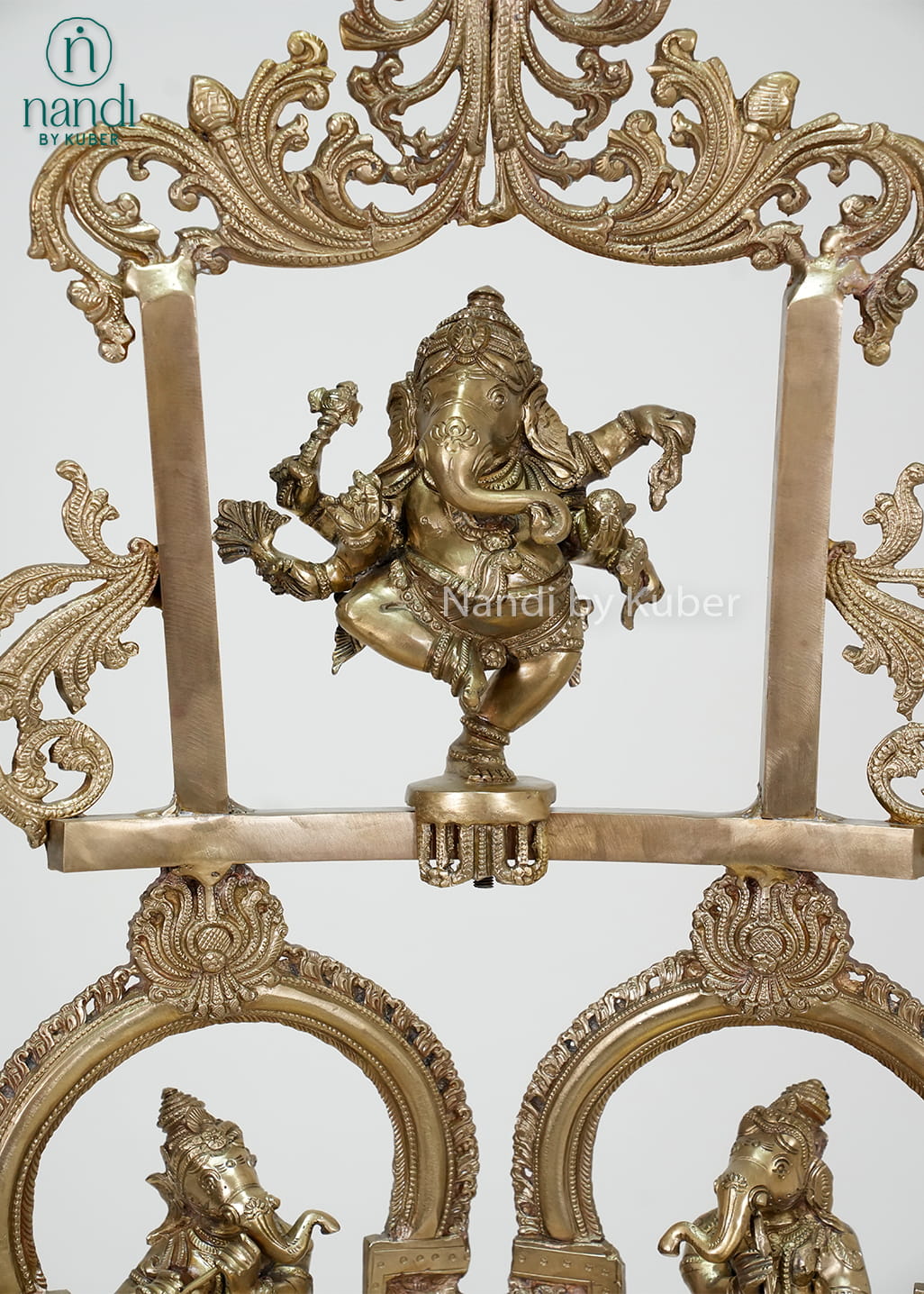 Decorative brass Ganesha urli with temple arch design, diya holders, and intricate detailing