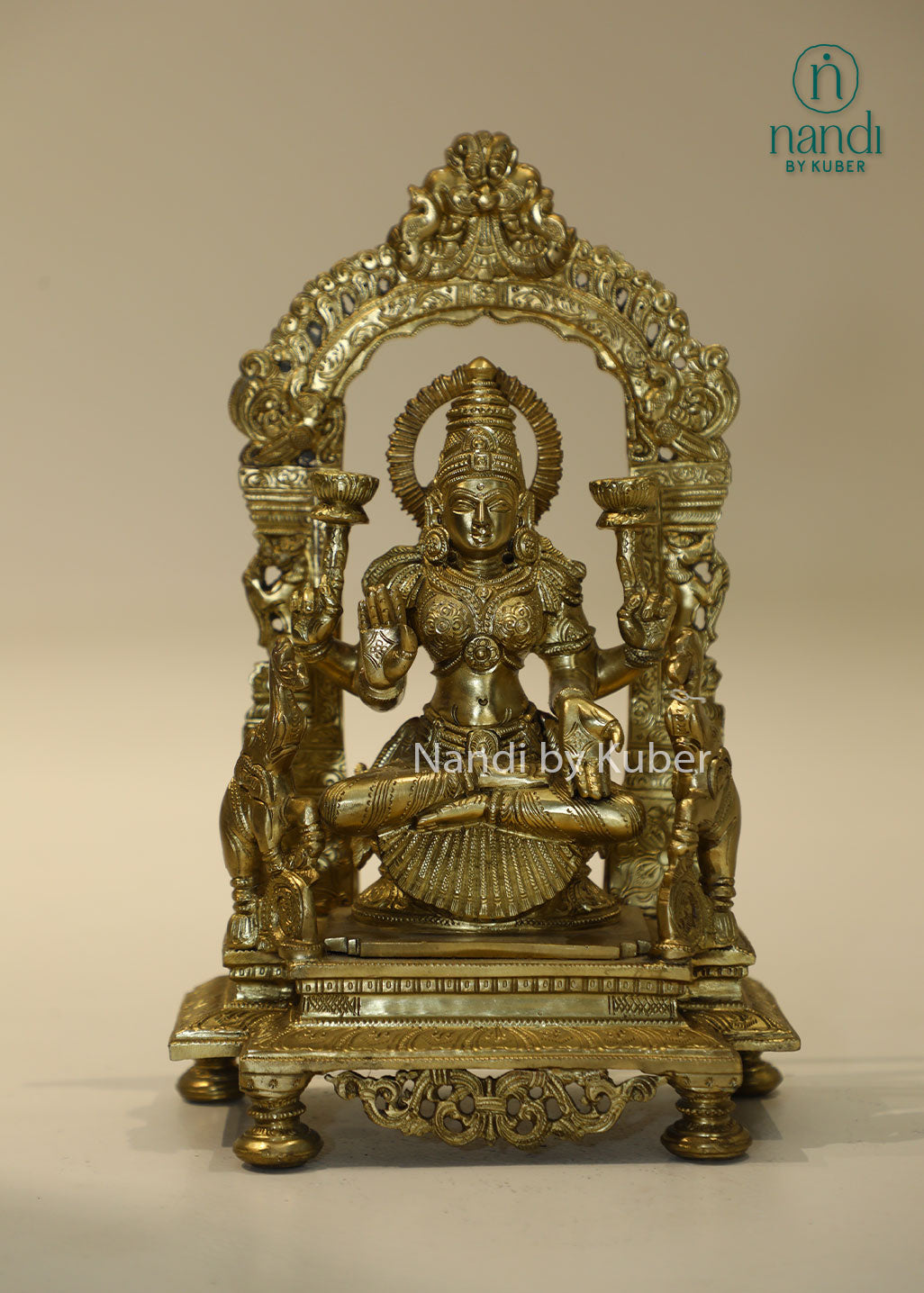 Bronze Goddess Lakshmi idol with decorative arch, handcrafted Hindu deity statue for home temple, puja room décor, Diwali decoration, wealth and prosperity worship, spiritual gifting, and religious collectible.
