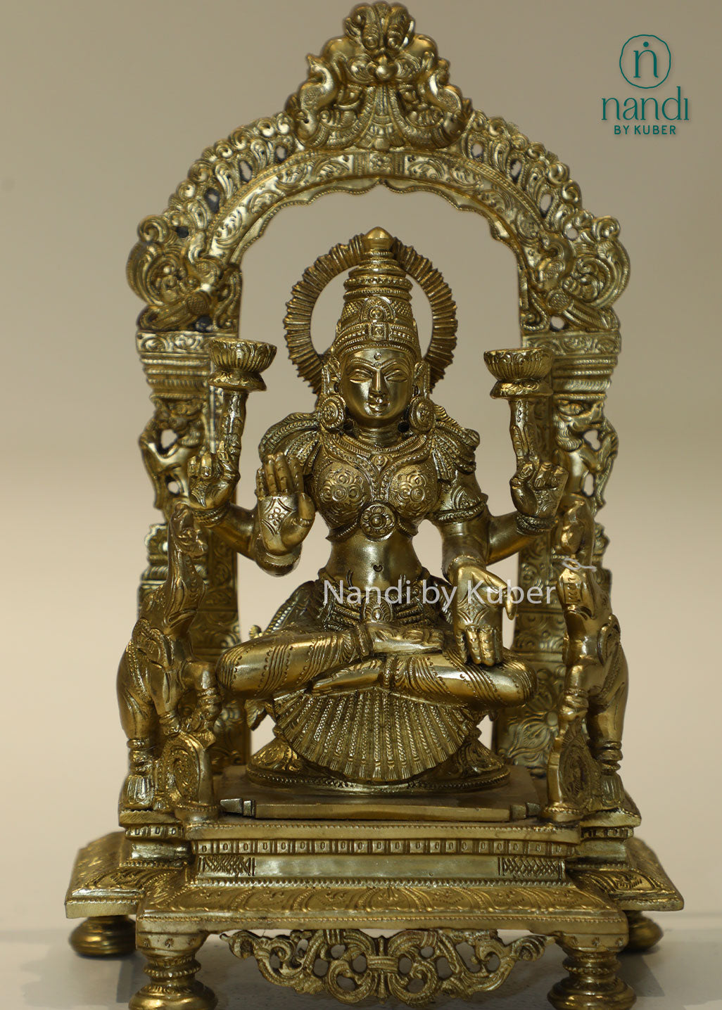 Bronze Goddess Lakshmi idol with decorative arch, handcrafted Hindu deity statue for home temple, puja room décor, Diwali decoration, wealth and prosperity worship, spiritual gifting, and religious collectible.