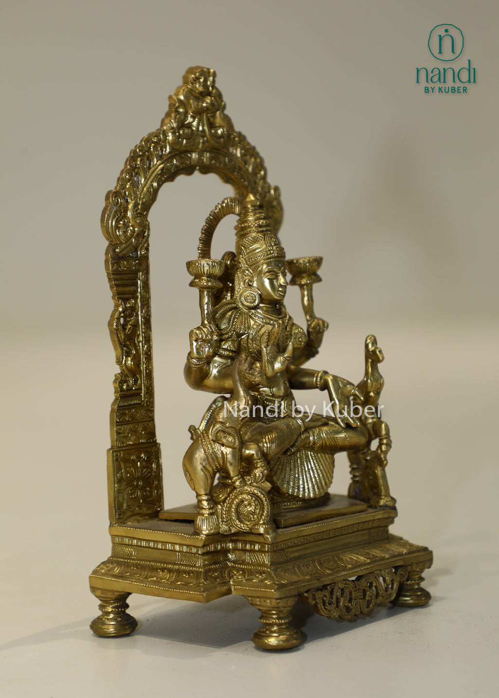 Bronze Goddess Lakshmi idol with decorative arch, handcrafted Hindu deity statue for home temple, puja room décor, Diwali decoration, wealth and prosperity worship, spiritual gifting, and religious collectible.