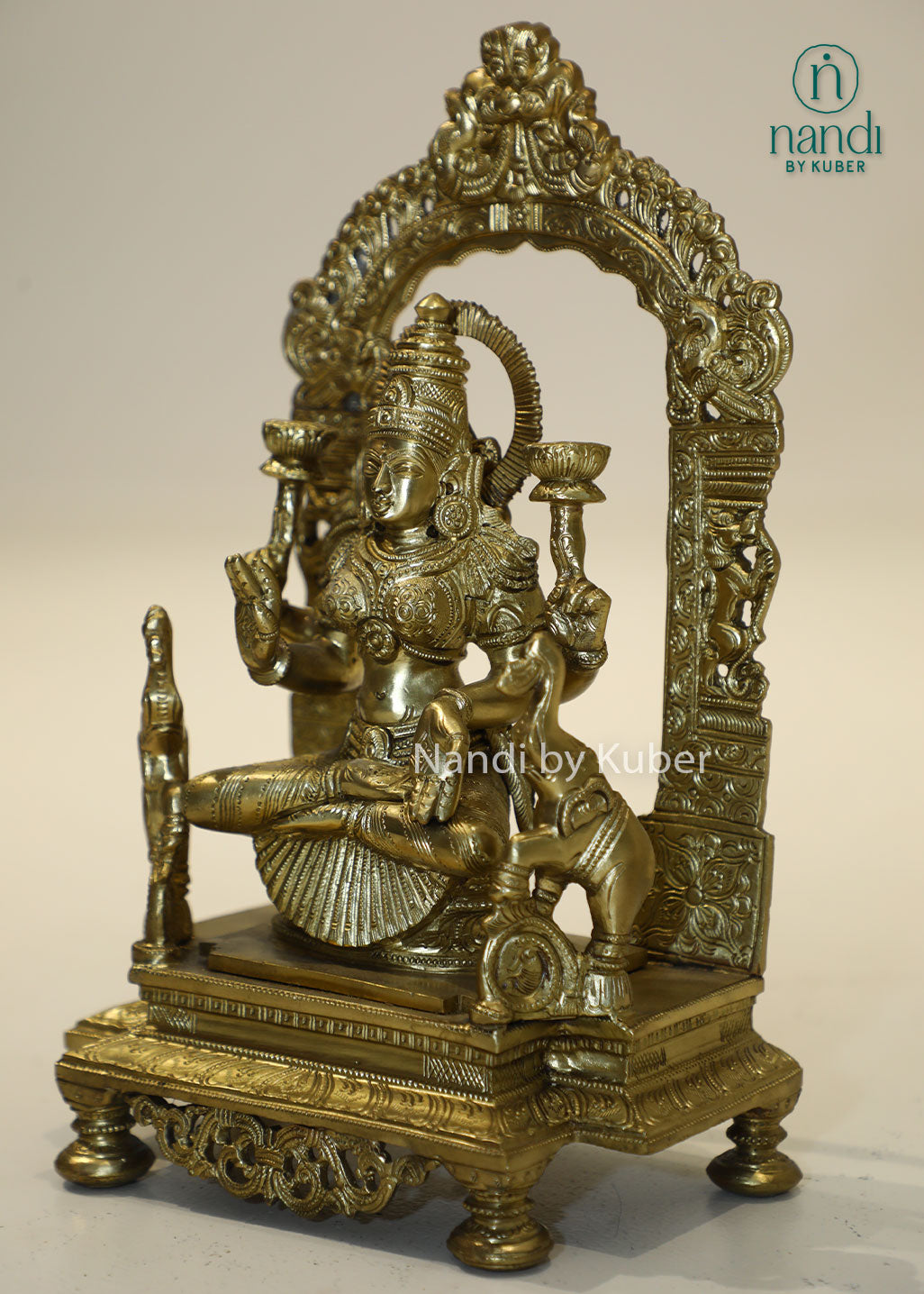 Bronze Goddess Lakshmi idol with decorative arch, handcrafted Hindu deity statue for home temple, puja room décor, Diwali decoration, wealth and prosperity worship, spiritual gifting, and religious collectible.