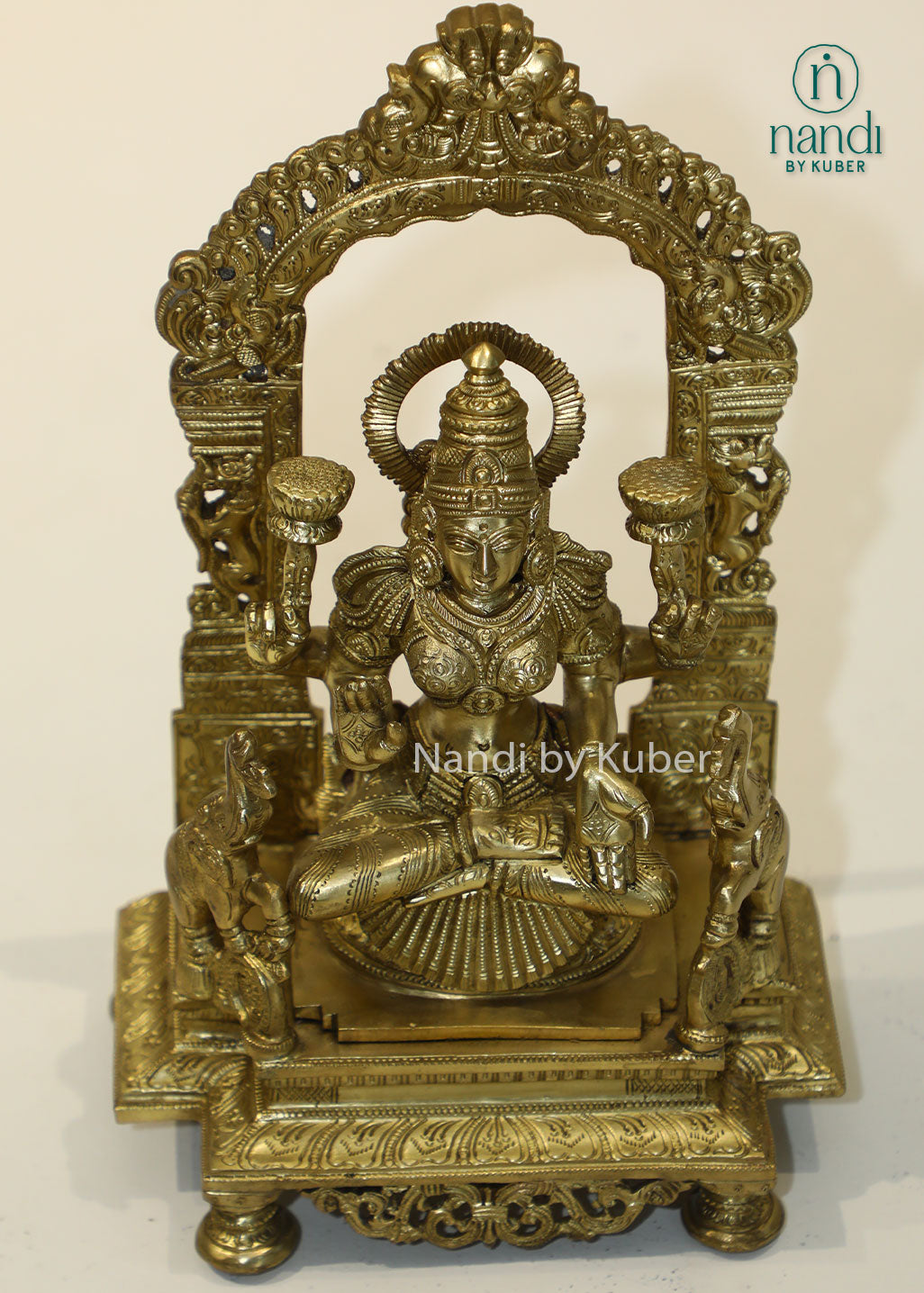 Bronze Goddess Lakshmi idol with decorative arch, handcrafted Hindu deity statue for home temple, puja room décor, Diwali decoration, wealth and prosperity worship, spiritual gifting, and religious collectible.